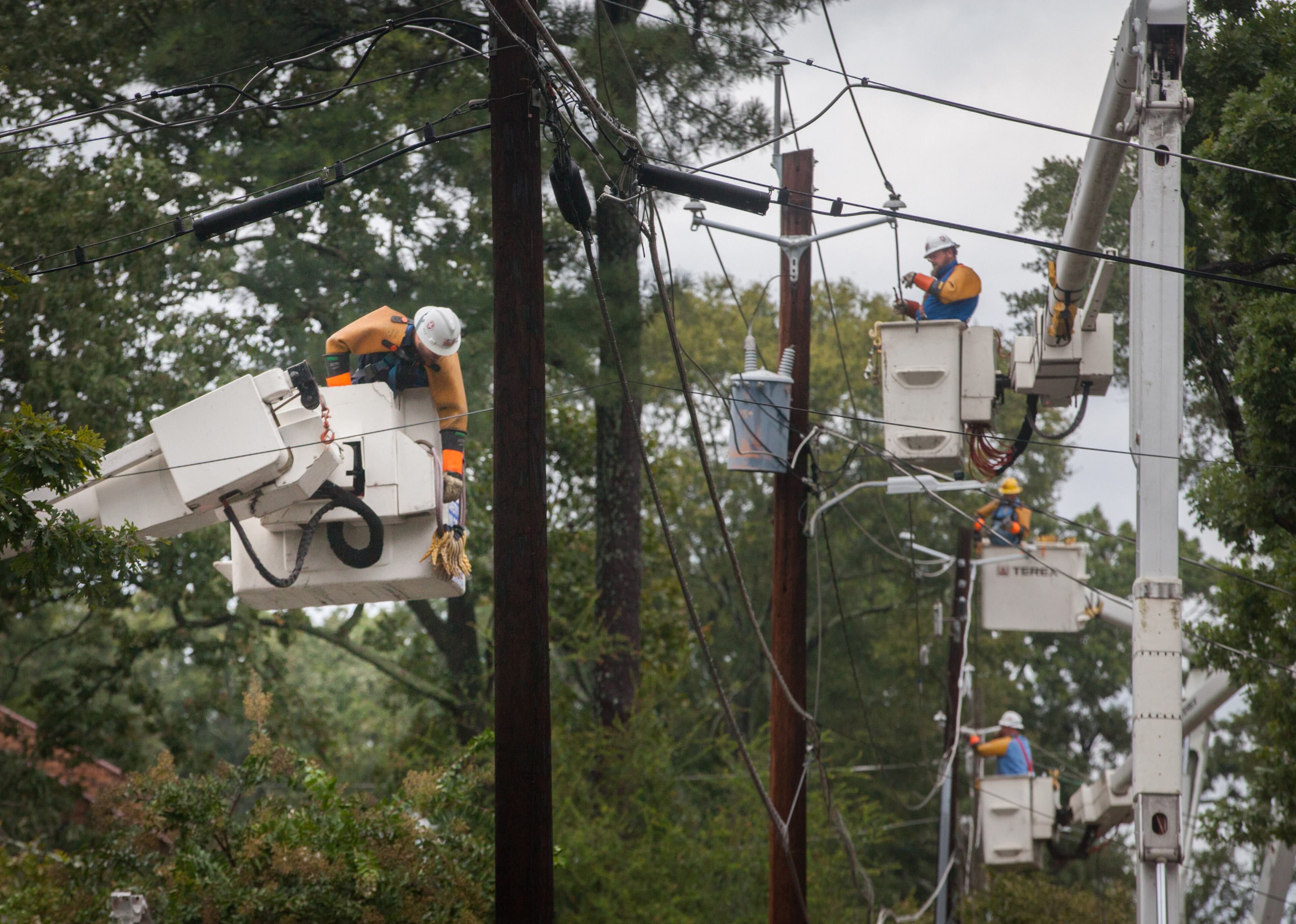 Workers from Utility Lines Construction Services, a Delaware based company, work to restore power on Adair Street, Tuesday, Sept. 12, 2017, in Decatur, Ga. BRANDEN CAMP/SPECIAL