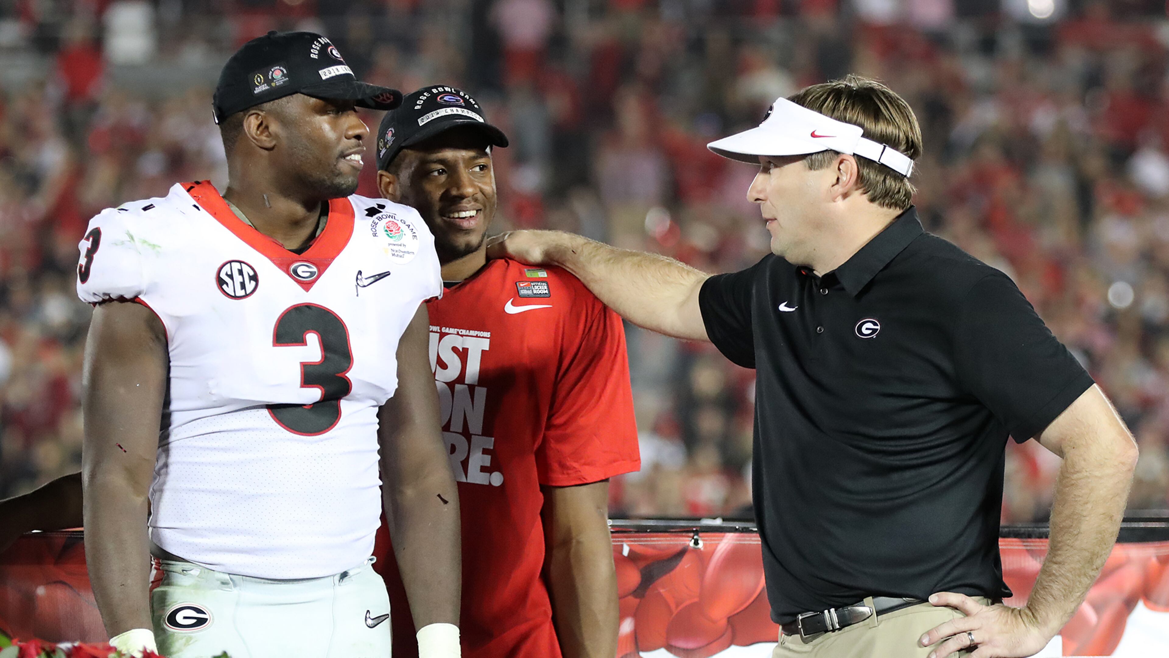 Georgia coach Kirby Smart stands on stage with Roquan Smith and Nick Chubb after beating Oklahoma 54-48 during double over time in the College Football Playoff Semifinal at the Rose Bowl Game on Monday, January 1, 2018, in Pasadena. Curtis Compton/ccompton@ajc.com