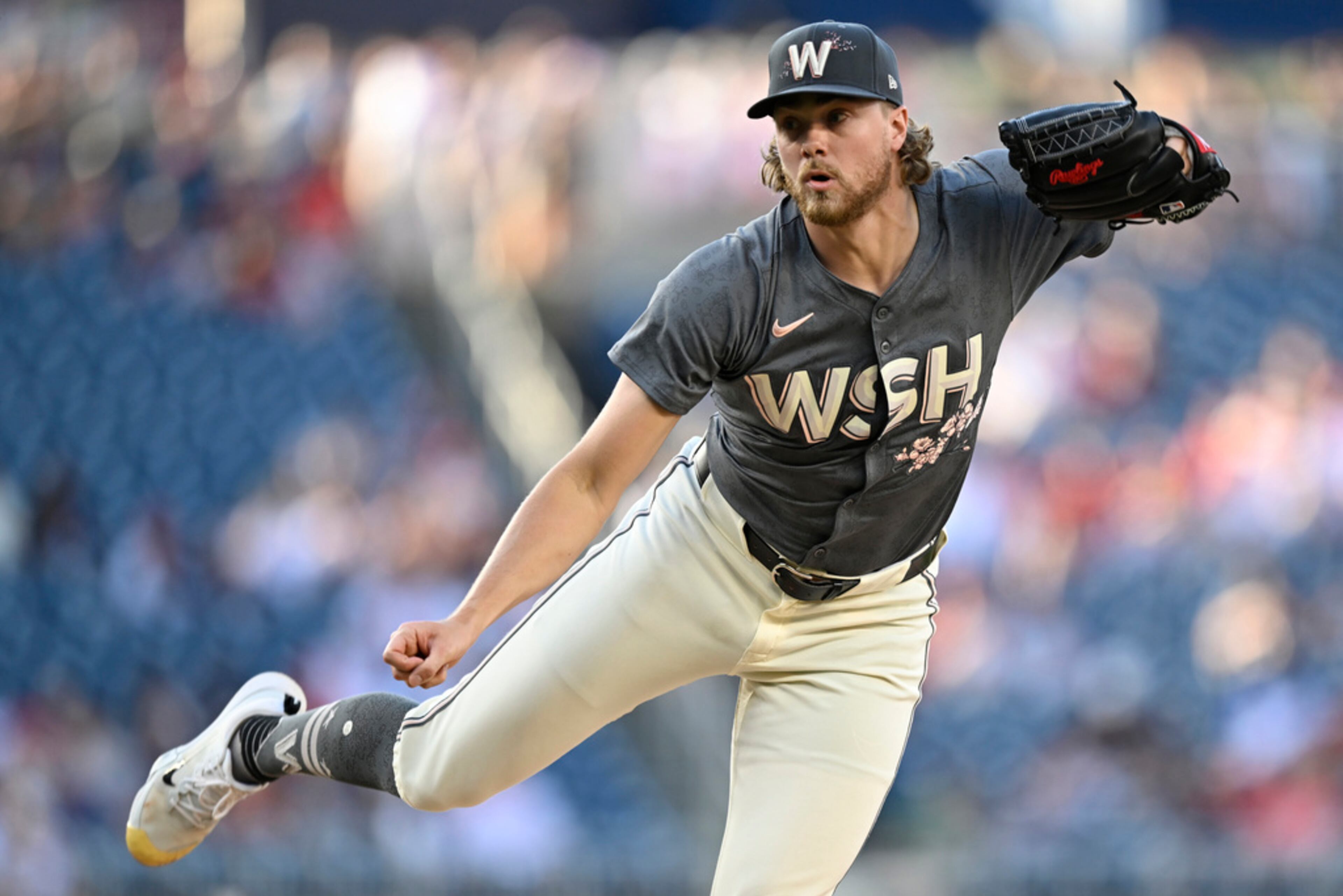 Washington Nationals starting pitcher Jake Irvin watches a throw to an Atlanta Braves batter during the first inning of a baseball game Friday, June 7, 2024, in Washington. (AP Photo/John McDonnell)