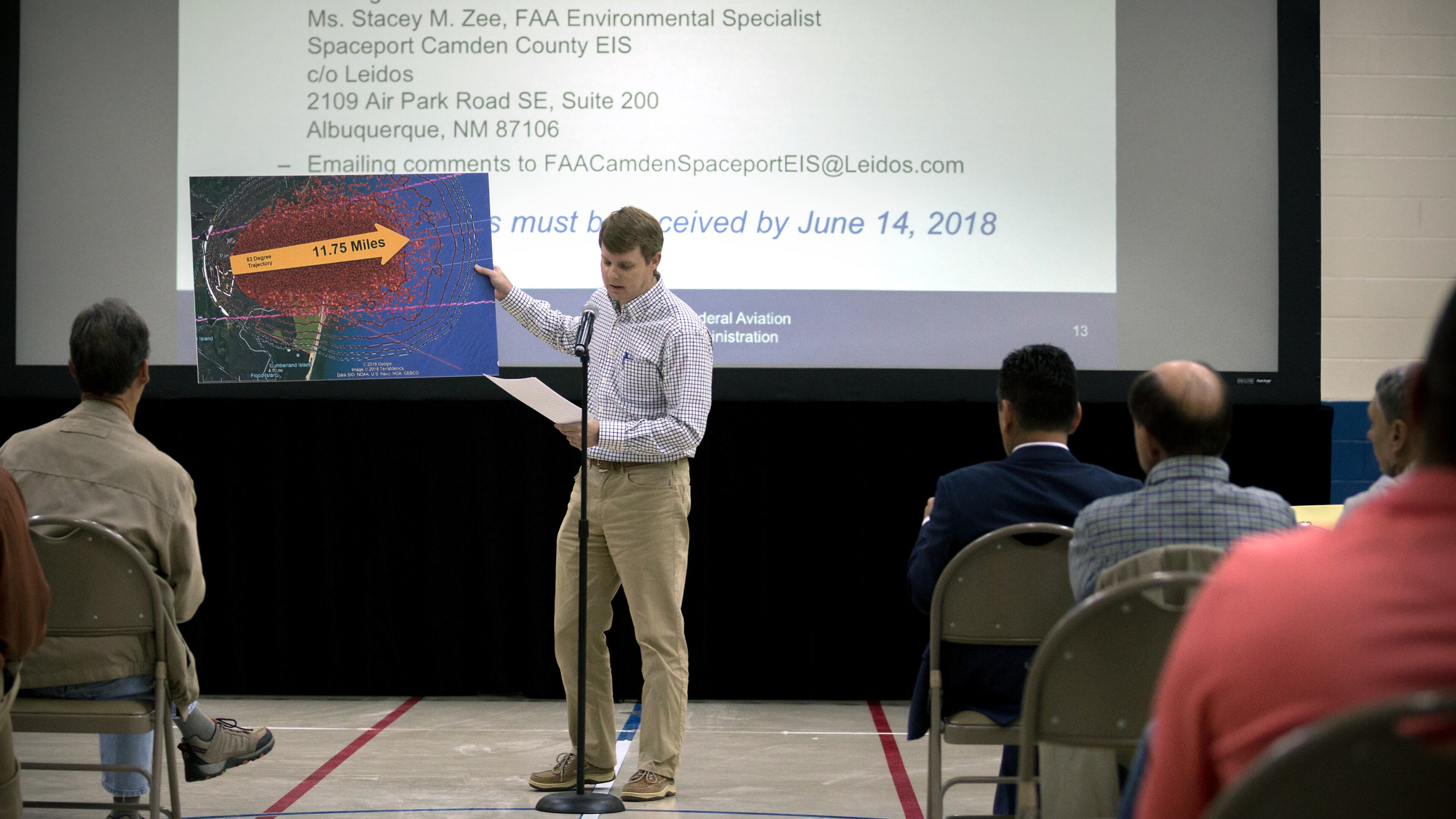 KINGSLAND, GA - APRIL 11, 2018: Camden County resident Kevin Lang, center, holds a graphic showing a model explosion pattern from a FAA study of a Falcon One Rocket during a public hearing to discuss during a public hearing about a potential site for a spaceport in Kingsland, Georgia. (AJC Photo/Stephen B. Morton)