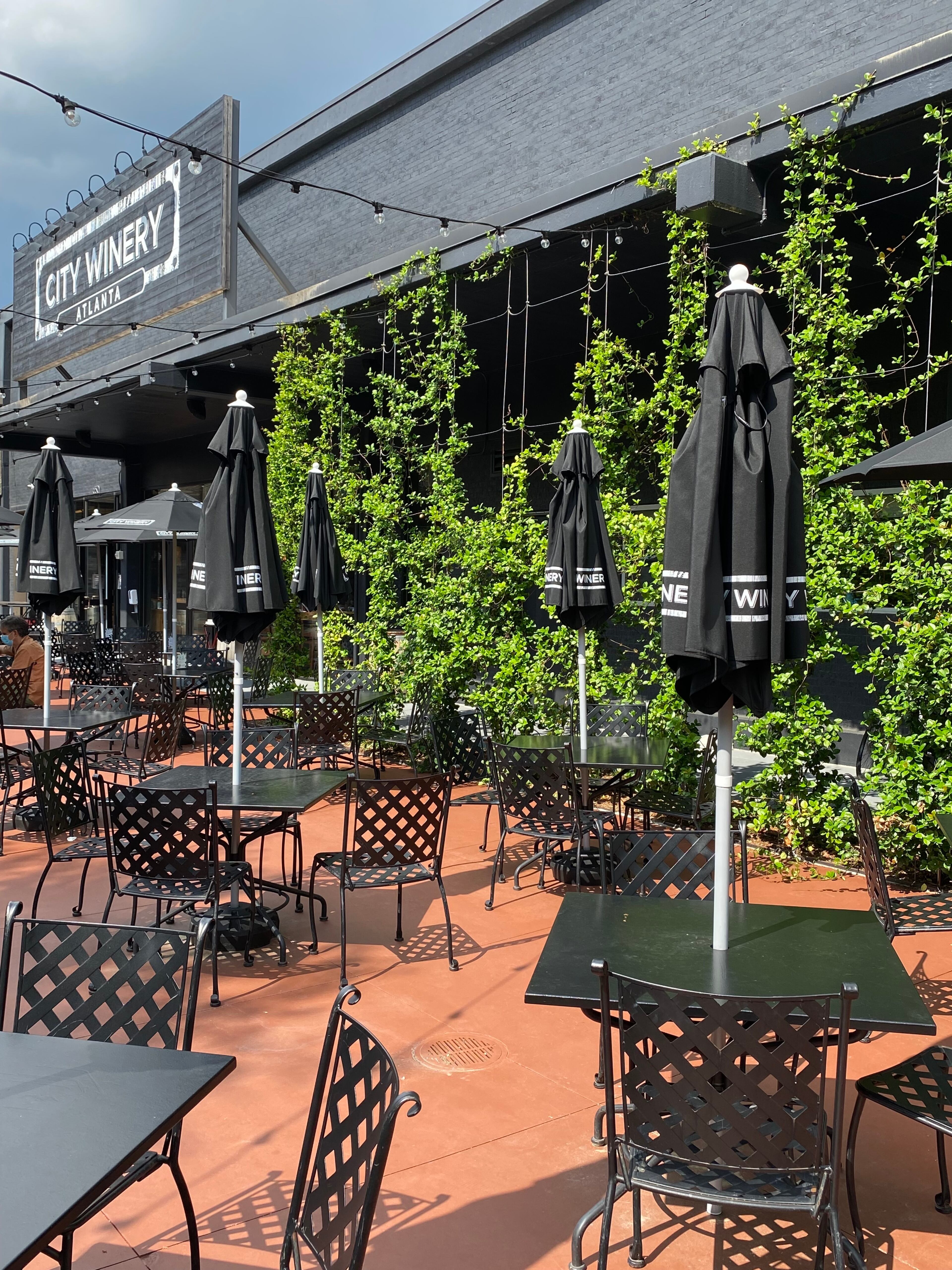 The May reopening of City Winery brought a revamped design with plenty of outdoor upgrades that include umbrella tables and plush lounge seating around a fire pit. (Ligaya Figueras / ligaya.figueras@ajc.com)