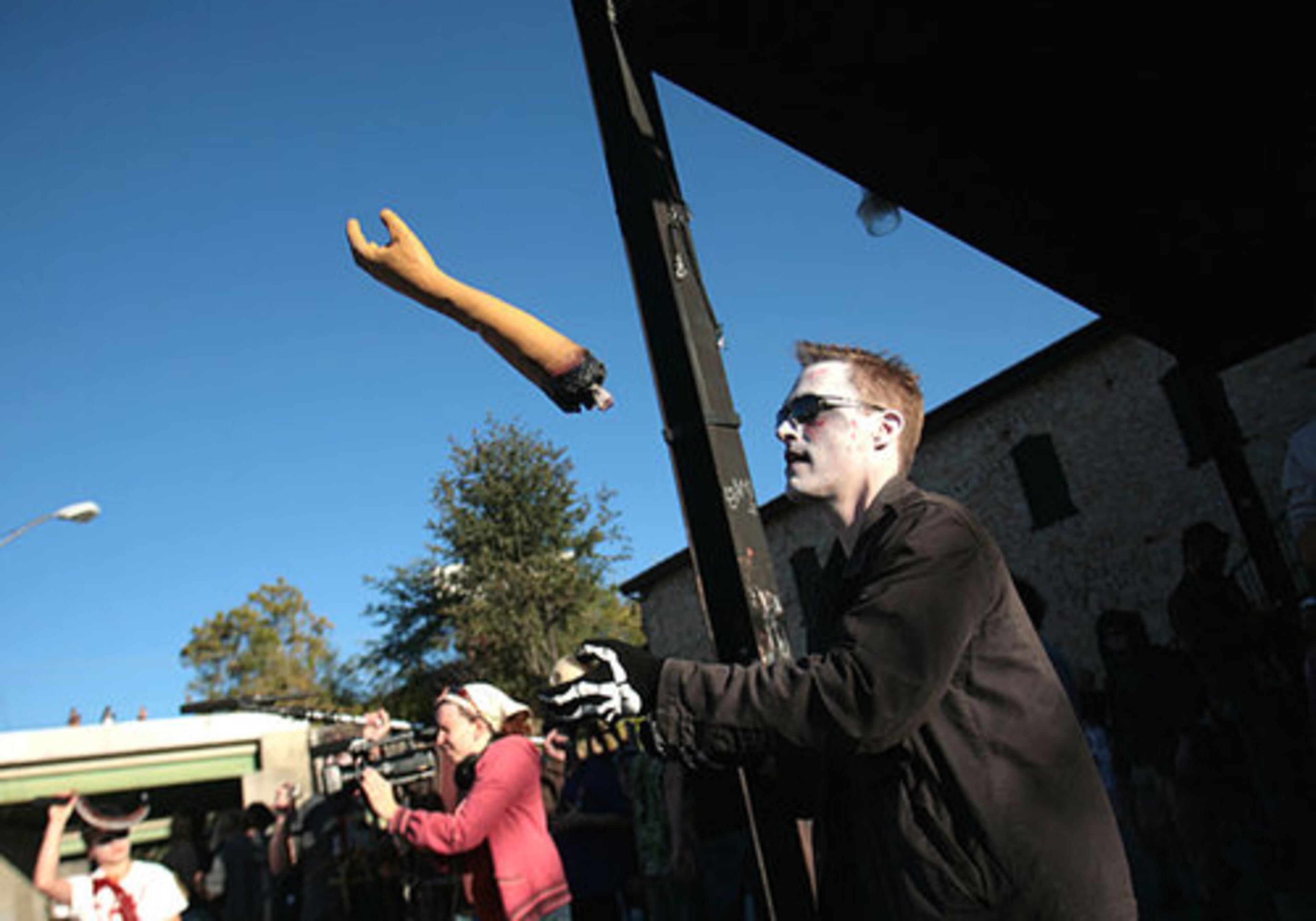 While waiting for the start of the Zombie Walk, James Abele of Atlanta juggles a severed arm outside the Masquerade.