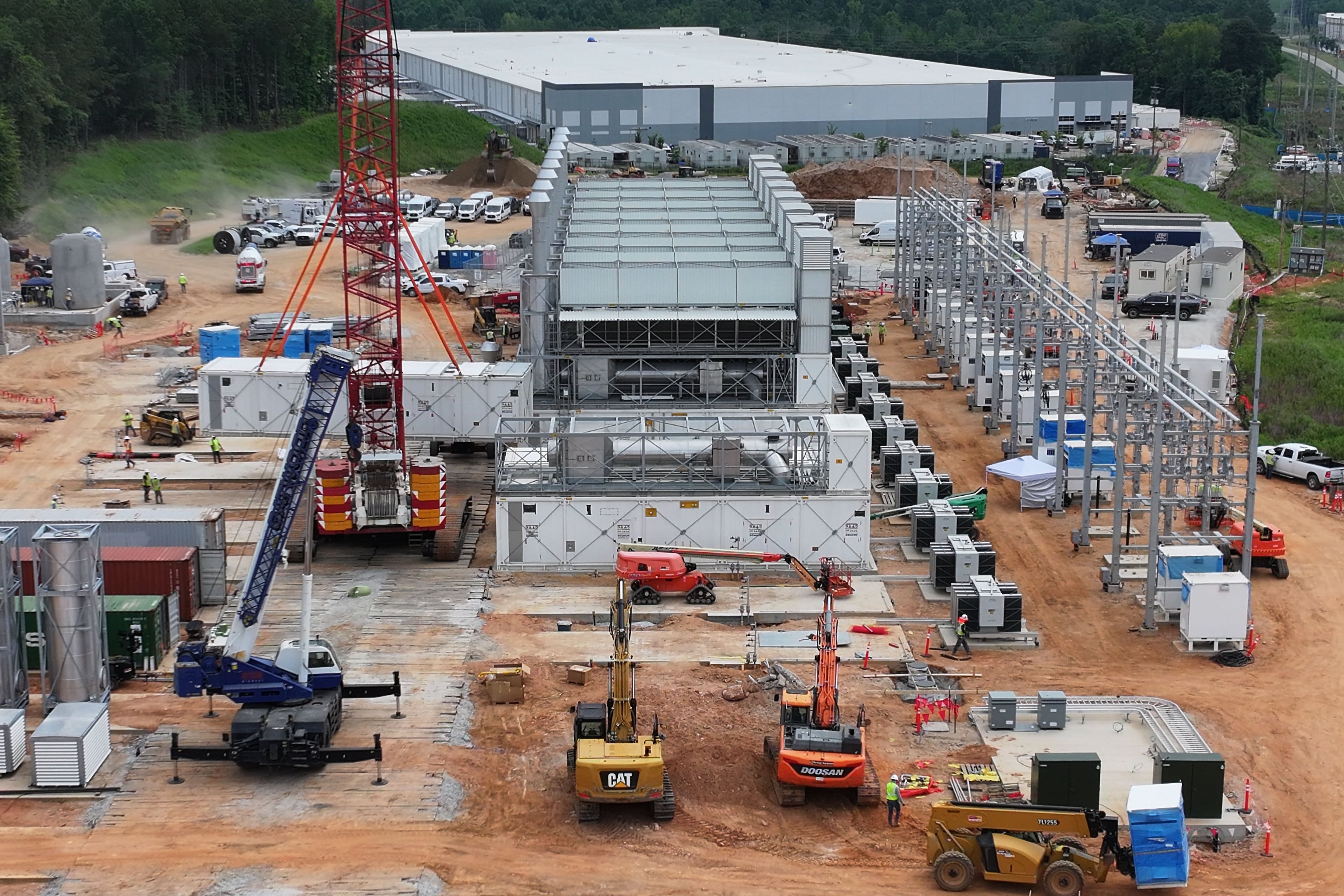Off-grid generators are being installed, with the data center in the background, on Thursday, June 25, 2026, in Covington. The company behind the project was installing equipment despite never getting proper permits from the state. (Hyosub Shin/AJC)
