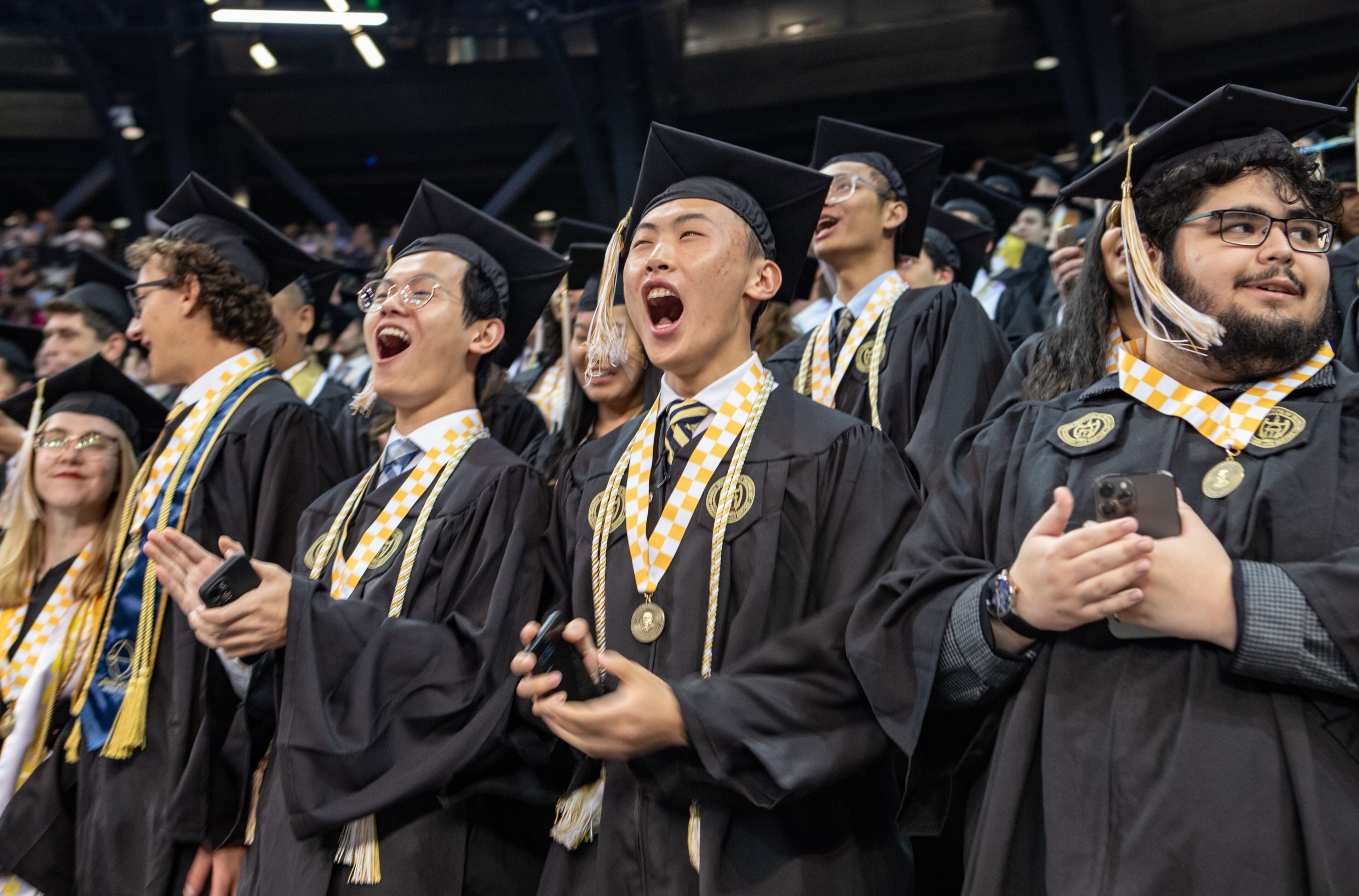 Marvin Ren, center, celebrates his graduation from Georgia Tech at McCamish Pavilion on Saturday, May 4, 2024 with he fellow mechanical engineering classmates. (Jenni Girtman for The Atlanta Journal-Constitution)
