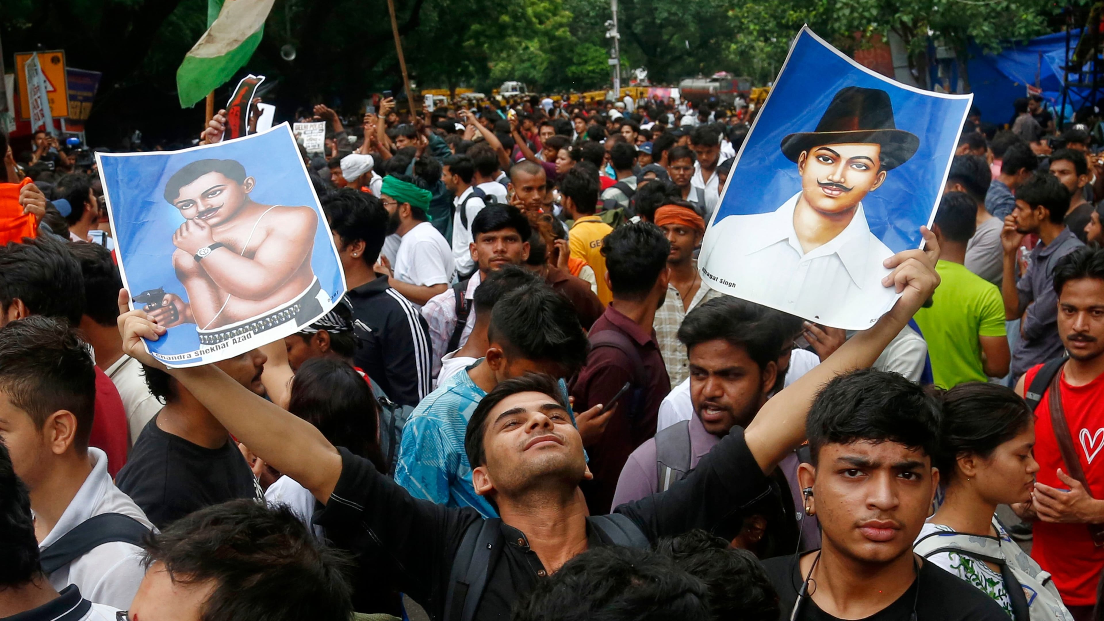 A supporter of the Cockroach Janta Party holds posters of Bhagat Singh, an Indian revolutionary freedom fighter, at Jantar Mantar in New Delhi, Tuesday, July 21, 2026. (AP Photo/Shekhar Yadav)