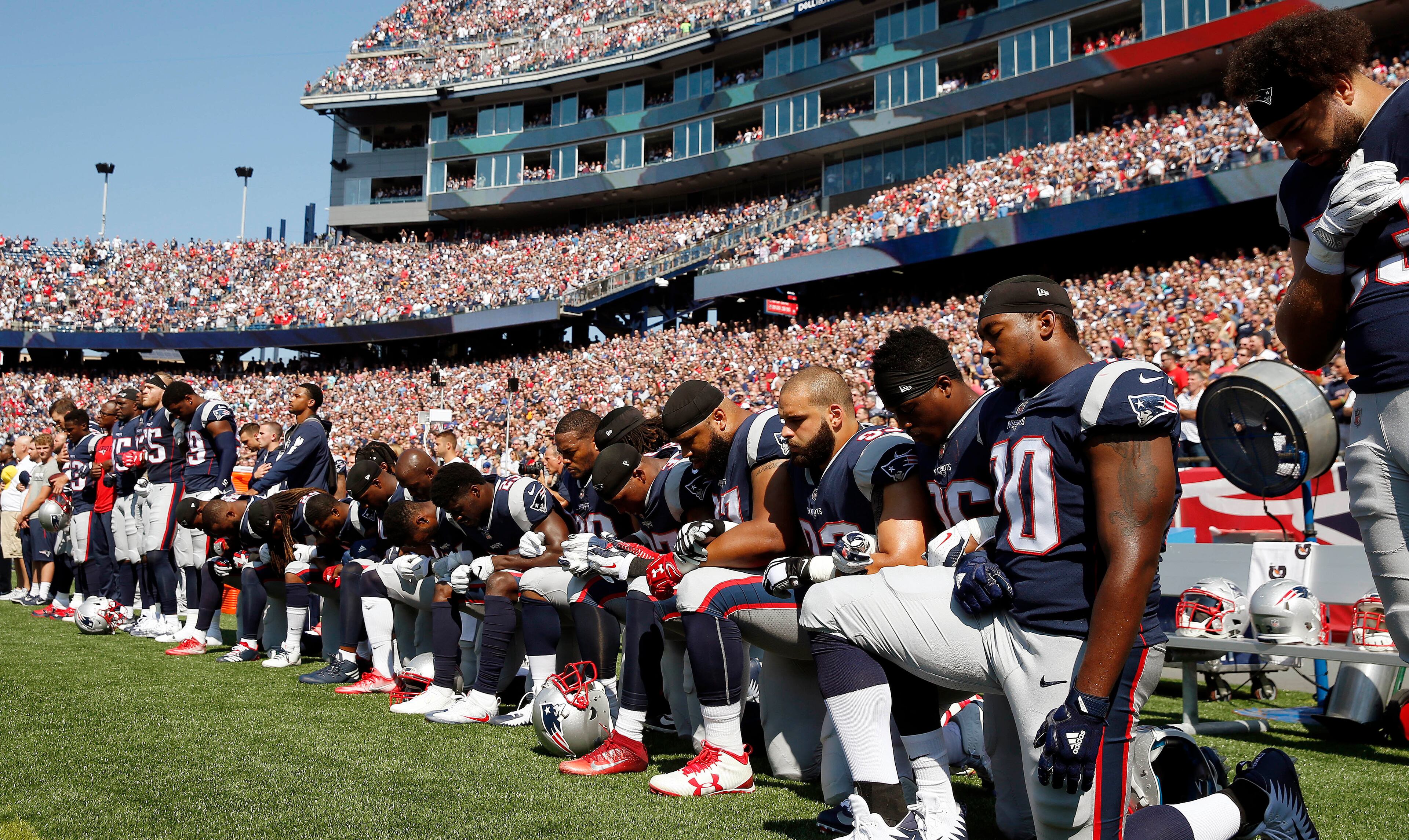 Several New England Patriots players kneel during the national anthem before an NFL football game against the Houston Texans, Sunday, Sept. 24, 2017, in Foxborough, Mass. (AP Photo/Michael Dwyer)