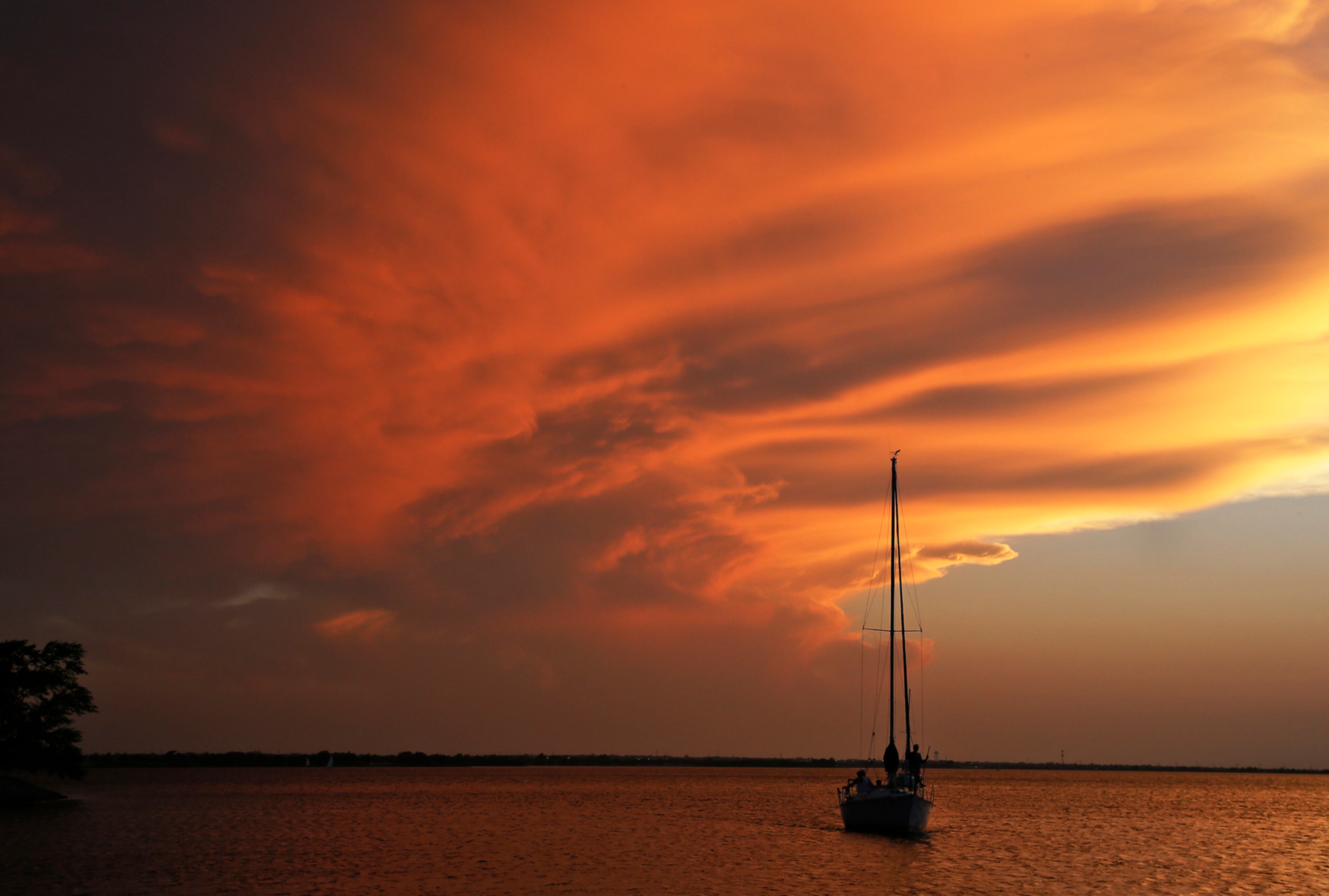 A boat returns to the harbor as the sun sets at Lake Hefner in Oklahoma City, Wednesday, June 14, 2017. (AP Photo/Sue Ogrocki)