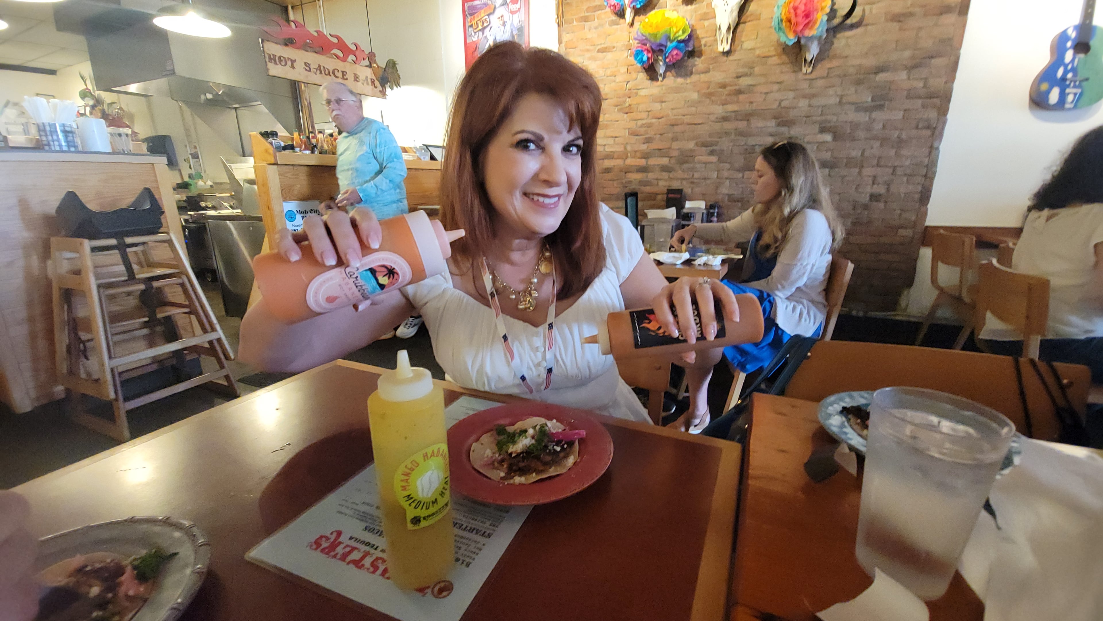 The author tries the hot sauces at Roosters Tacos & Tequila in Mobile, Alabama. (Courtesy of Wesley Teo)