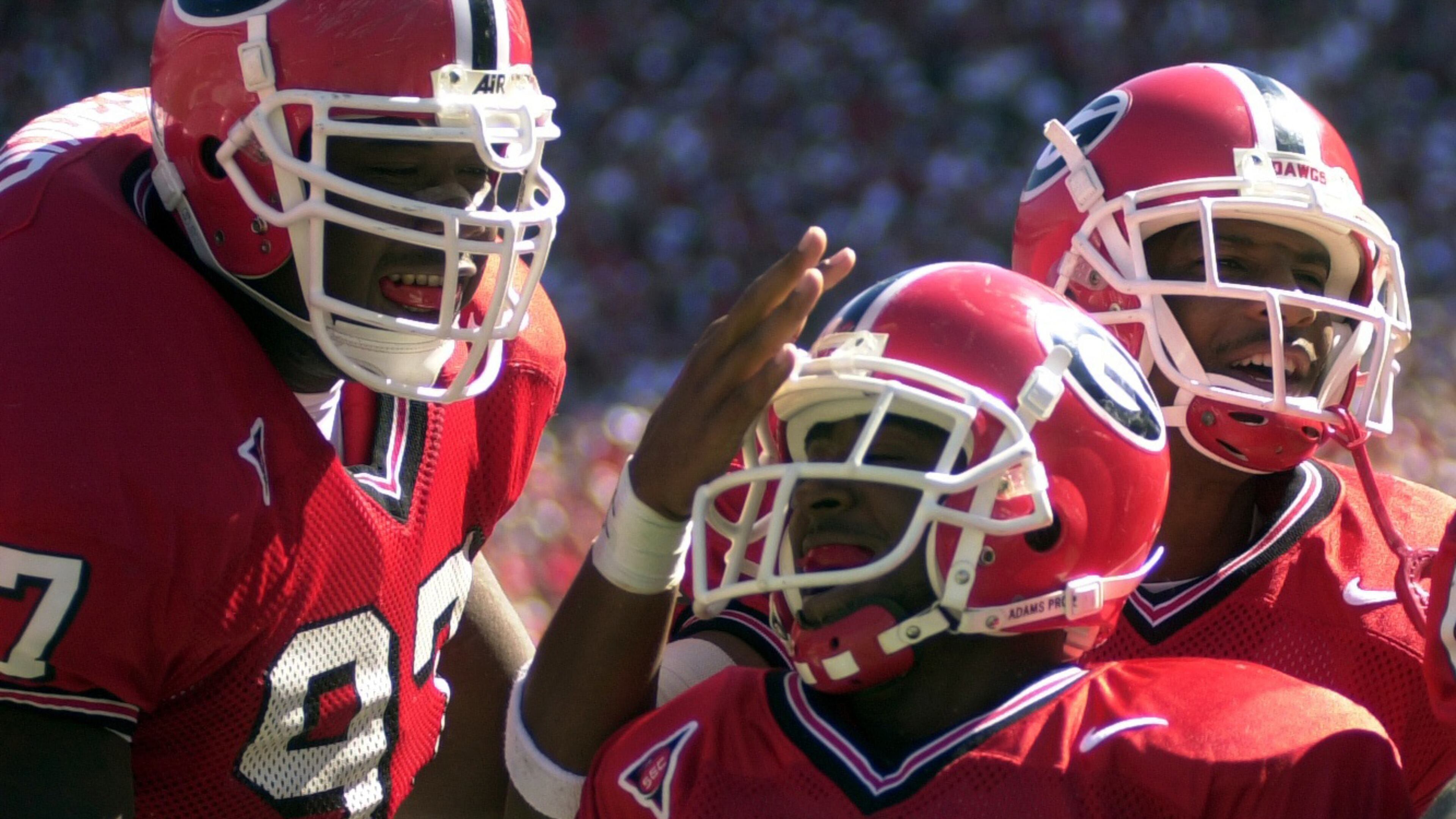 001014-ATHENS-Ga's #2 Tim Wansley (cq) raced back 62 yards for a touchdown in the2nd quarter Saturday, October 14, 2000 at Sanford Stadium. He is congratulated by #97 Marcus Stroud (cq) on his left...unidentified player on right.(T. LEVETTE BAGWELL/STAFF)