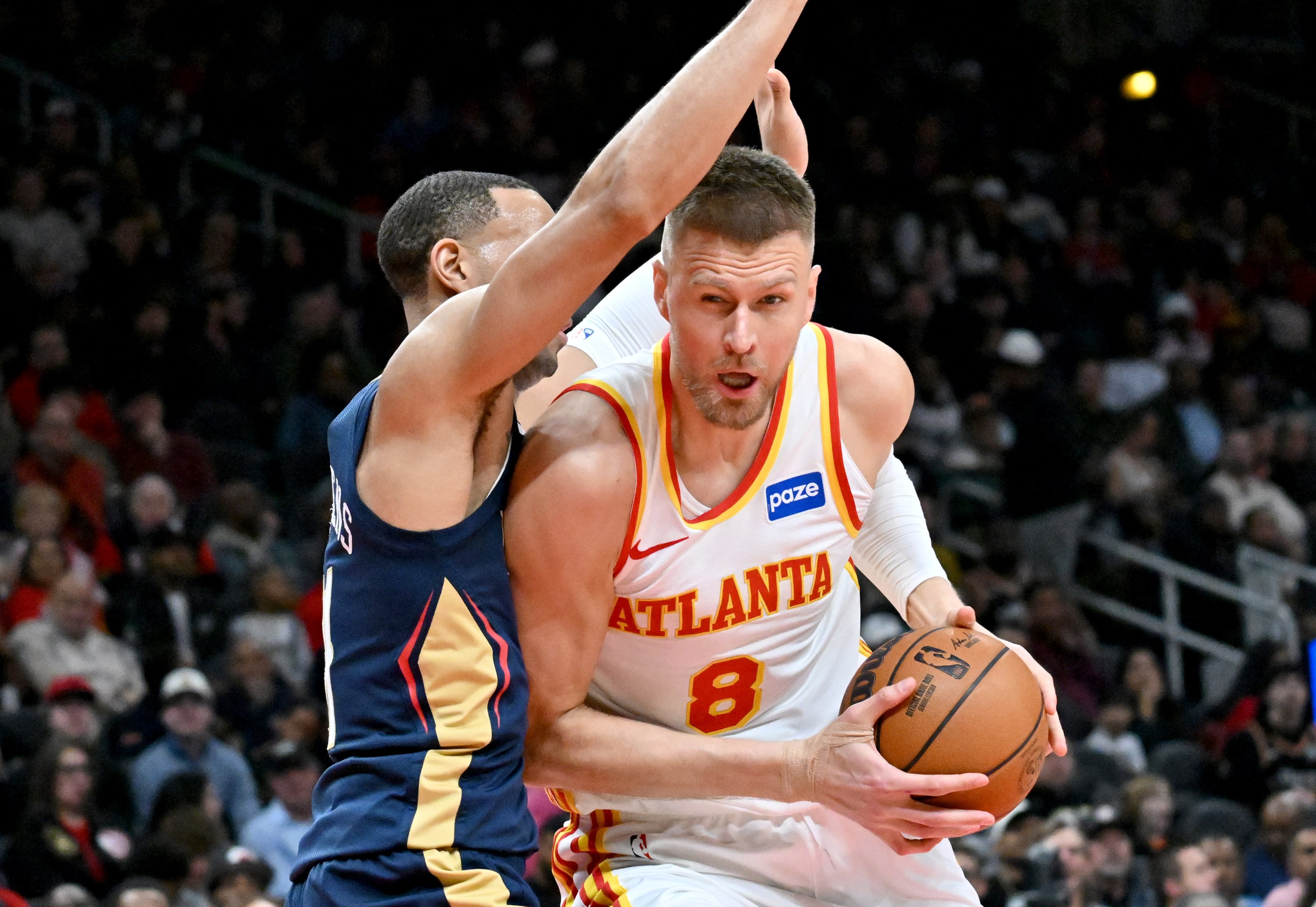 Atlanta Hawks forward/center Kristaps Porziņģis (8) drives against New Orleans Pelicans guard Bryce McGowens (11) during the first half in an NBA basketball game at State Farm Arena, Wednesday, Jan. 7, 2026, in Atlanta. (Hyosub Shin/AJC)