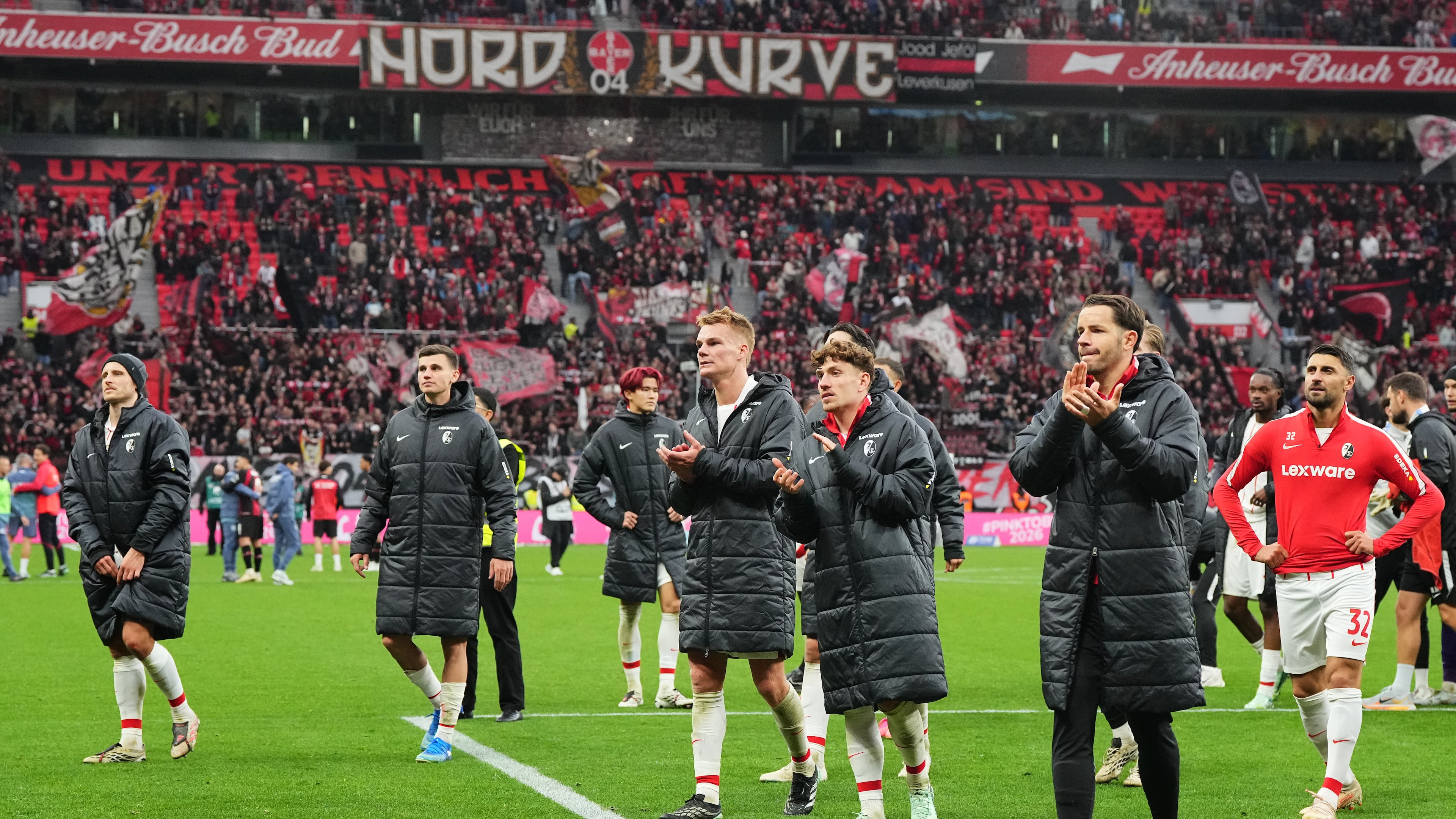 Freiburg's players walk in coats disappointed to their fans after losing the German Bundesliga soccer match between Bayer Leverkusen and SC Freiburg in Leverkusen, Germany, Sunday, Oct. 18, 2026. (AP Photo/Martin Meissner)