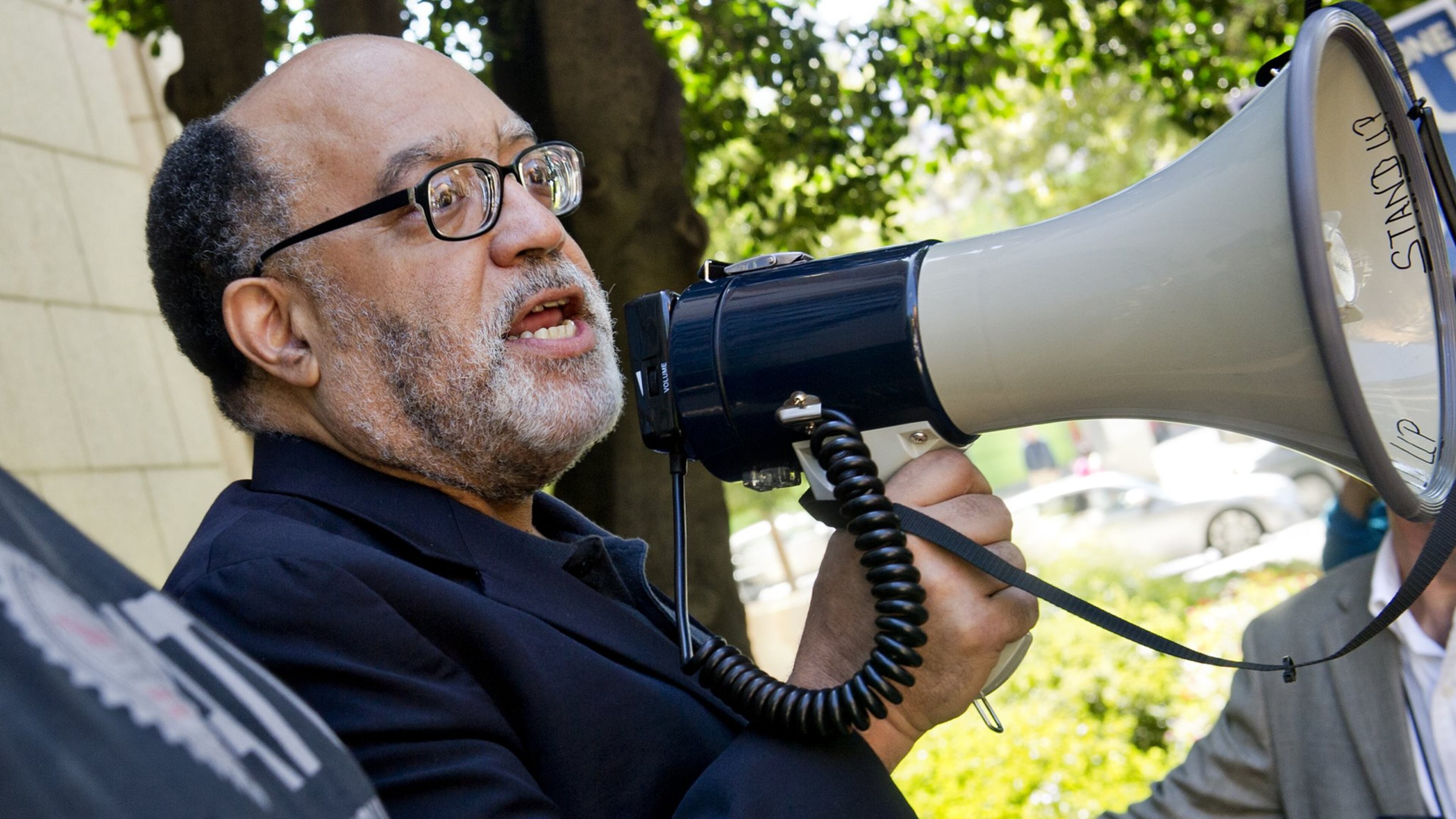 Then-senator Vincent Fort uses a bullhorn to speak to MARTA employees and retirees during union negotiations in front of the law offices of MARTA Board Chair Robbie Ashe on October 6, 2014, in Atlanta. JONATHAN PHILLIPS / SPECIAL