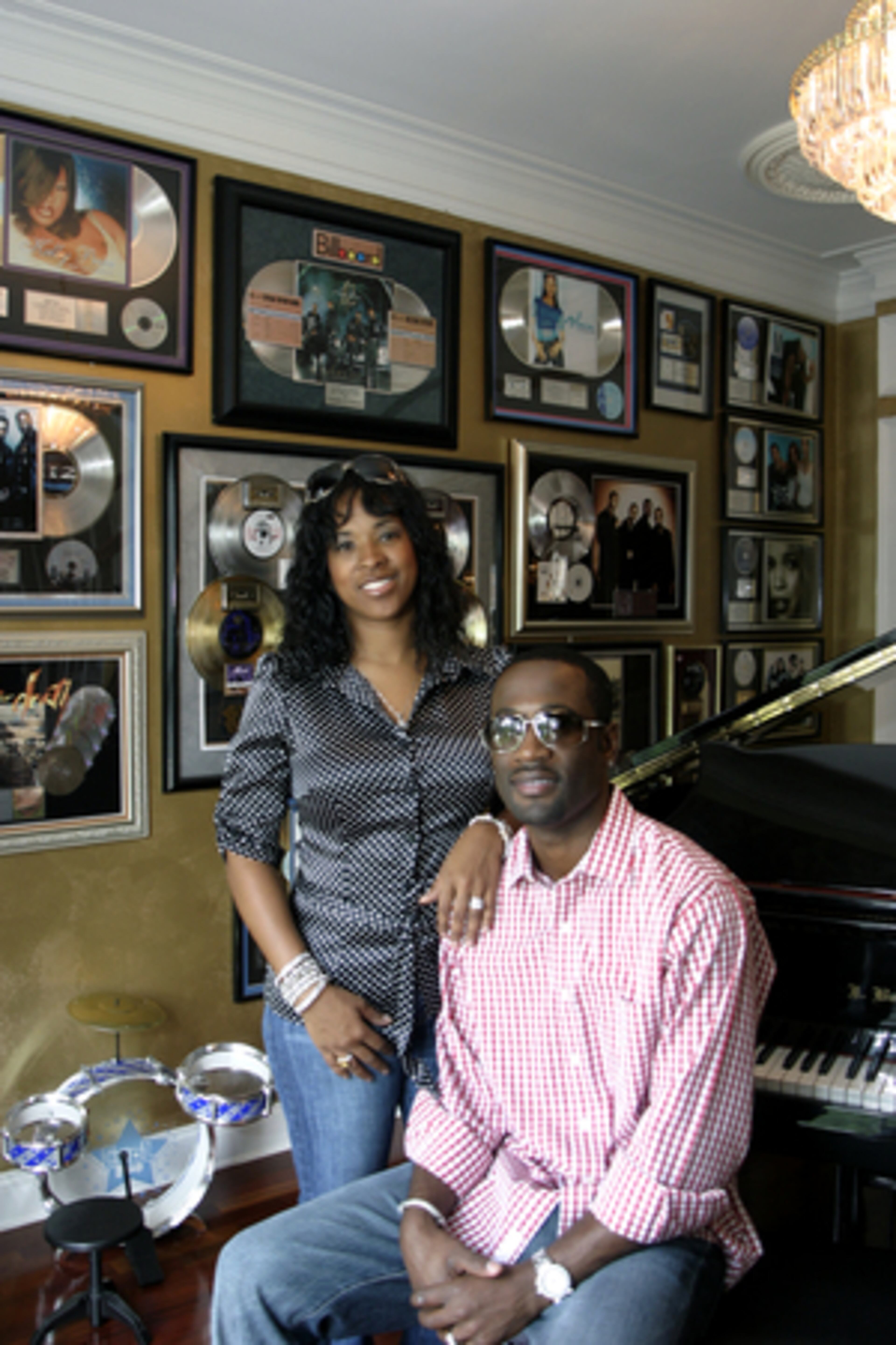 Sharlinda and Quinnes "Q" Parker in the piano room of their Mableton home. Record plaques hang on the wall, a testament to Q's work as a member of the R&B group One Twelve. Most of the artists mentioned have a connection to Parker either through performance, song writing or both.