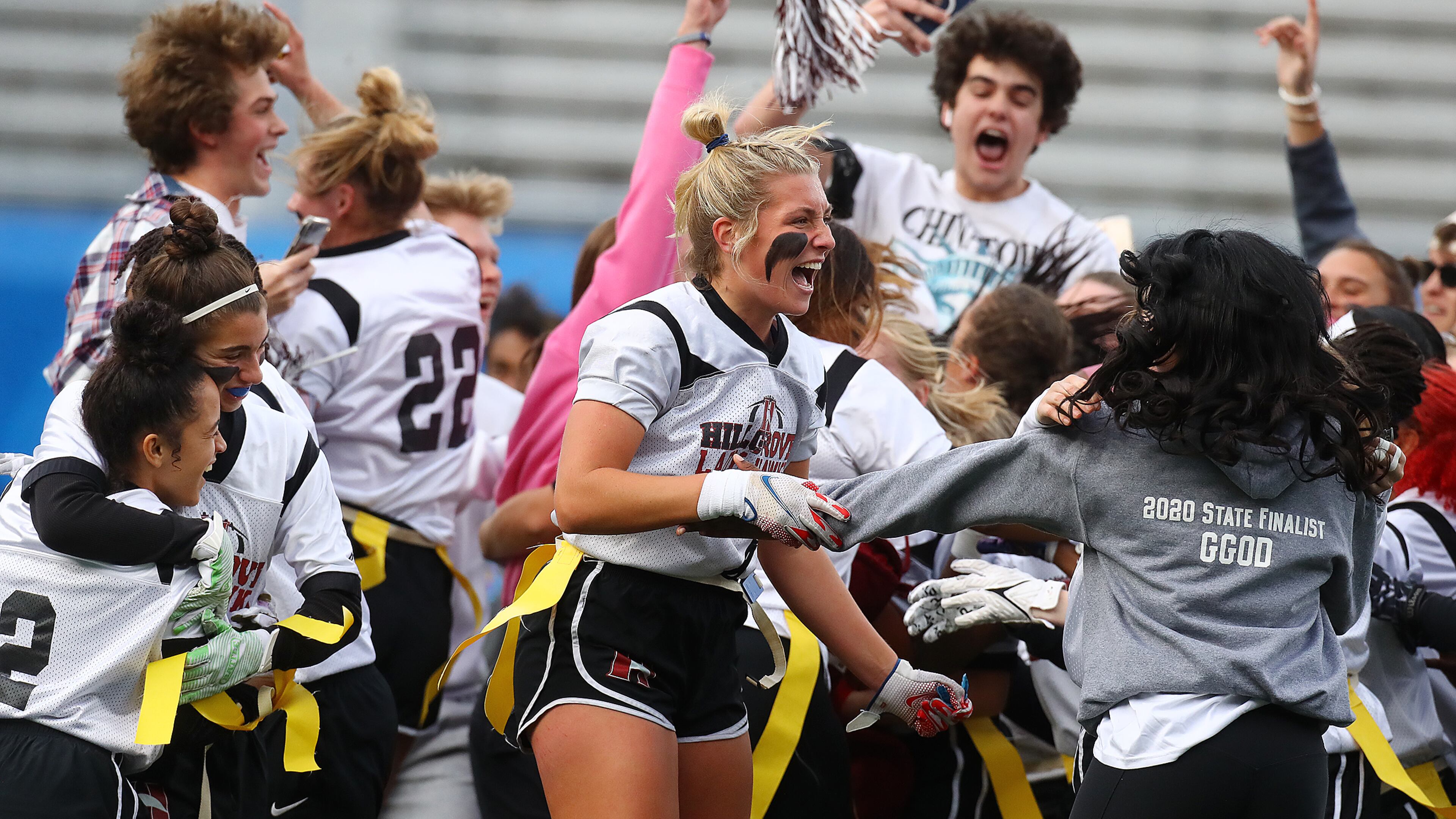 Hillgrove players and fans rush the field to celebrate a 20-6 victory over Marietta in their GHSA Flag Football Championship Division 3 game on Thursday, Dec 9, 2021, in Atlanta. “Curtis Compton / Curtis.Compton@ajc.com”`