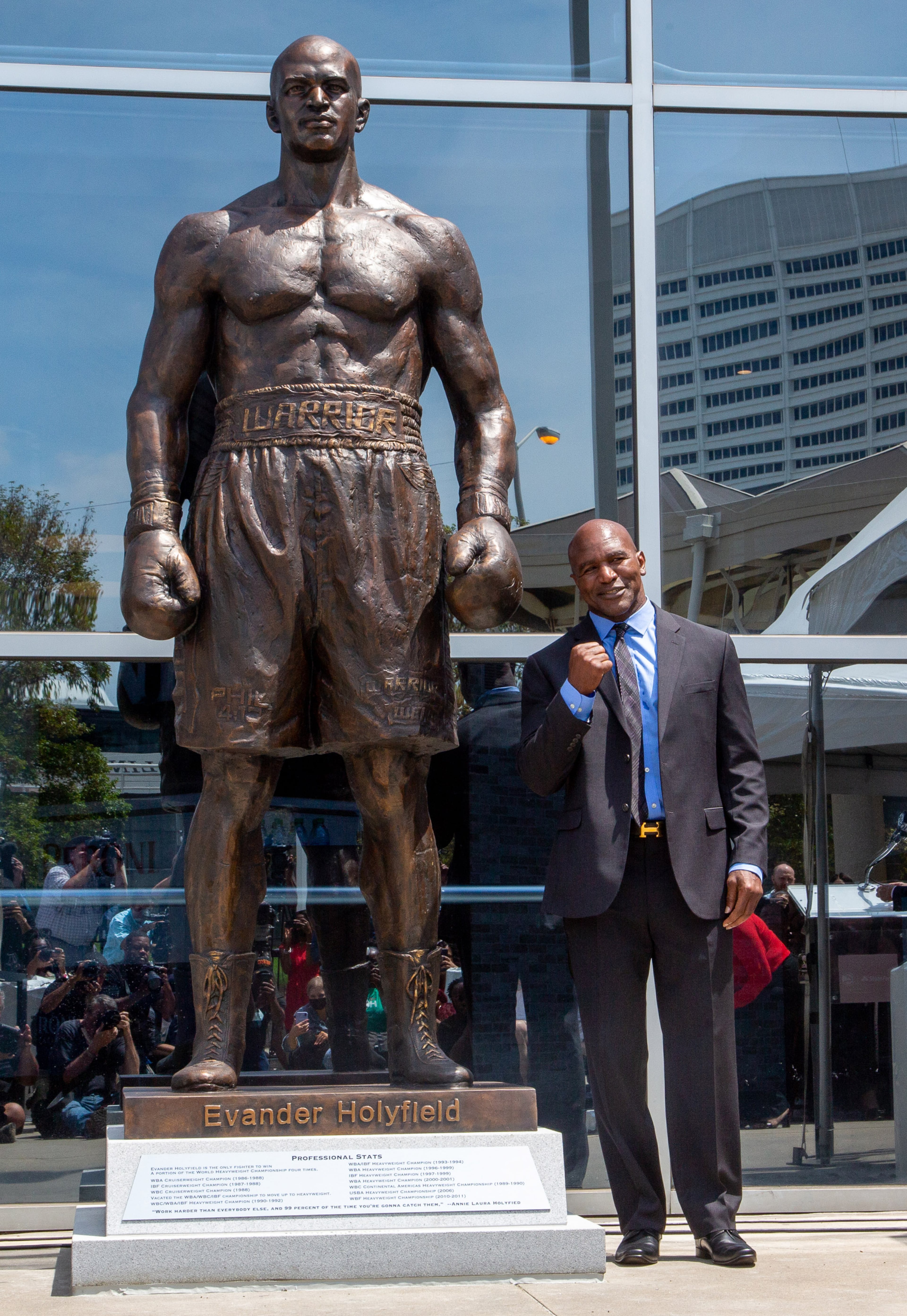 Legendary boxer Evander Holyfield stands next to a bronze statue of himself at State Farm Arena this Friday, June 25. STEVE SCHAEFER FOR THE ATLANTA JOURNAL-CONSTITUTION
