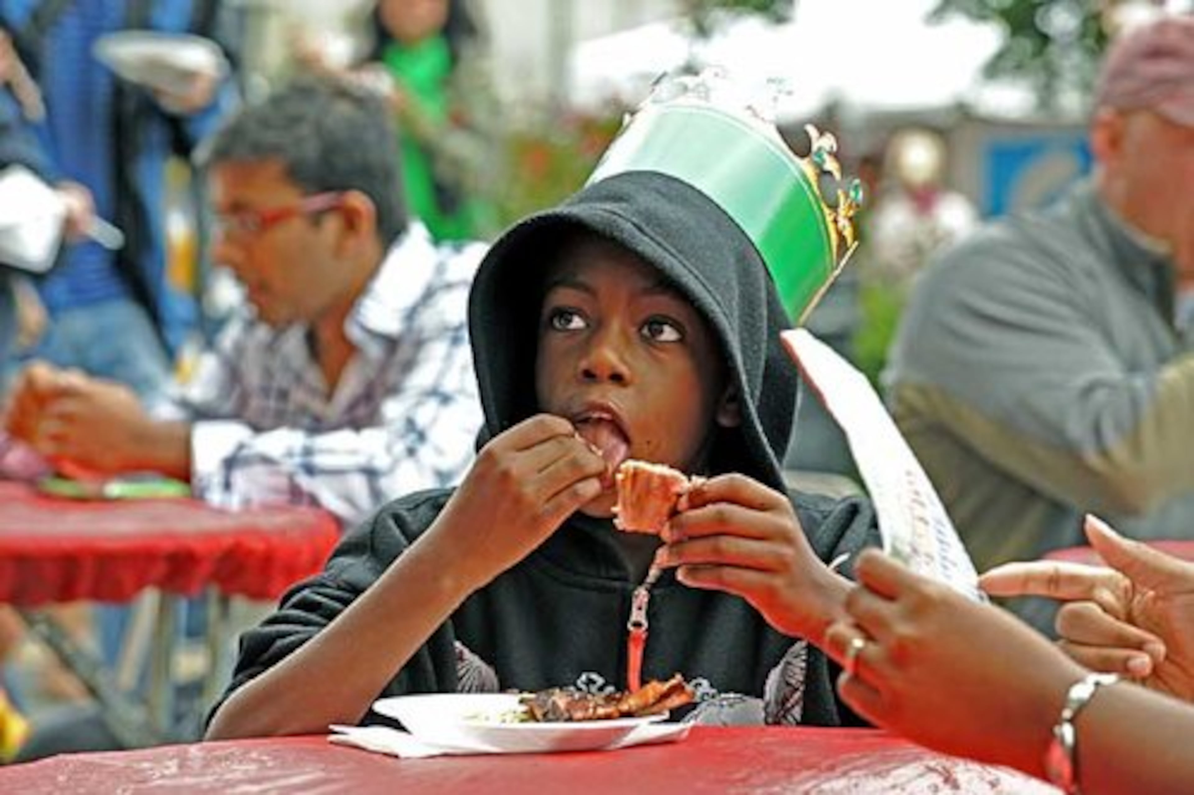 Marques Watts, 9, of Atlanta, enjoys some ribs from Jim 'n Nick's Bar-B-Q. Sunday (10/12/08) during Taste of Atlanta .