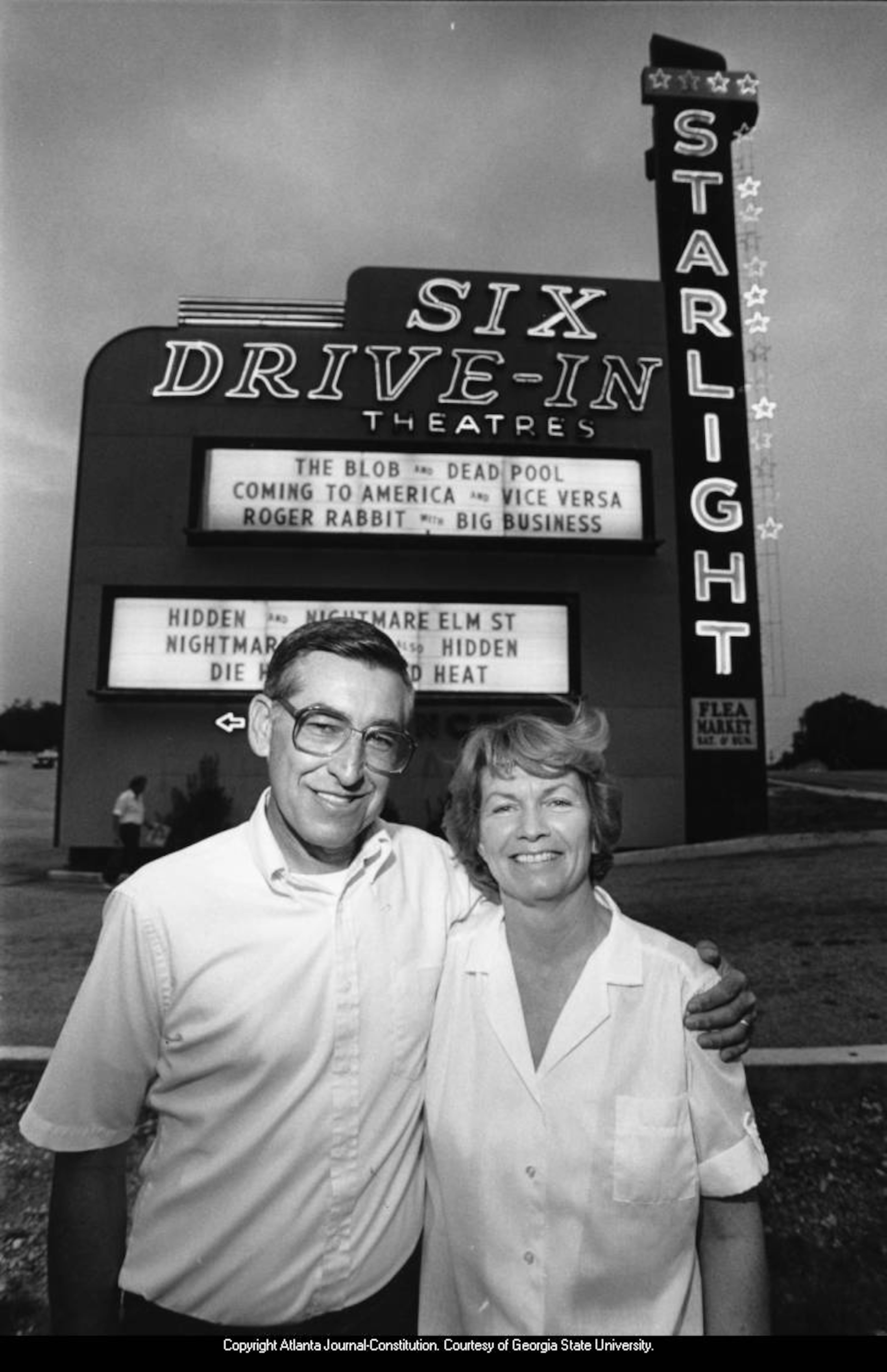 1988 -- Starlight Drive-In manager Ron Bacon and his wife, Marilyn, pose next to the theater's marquee. ANDY SHARP / AJC FILE