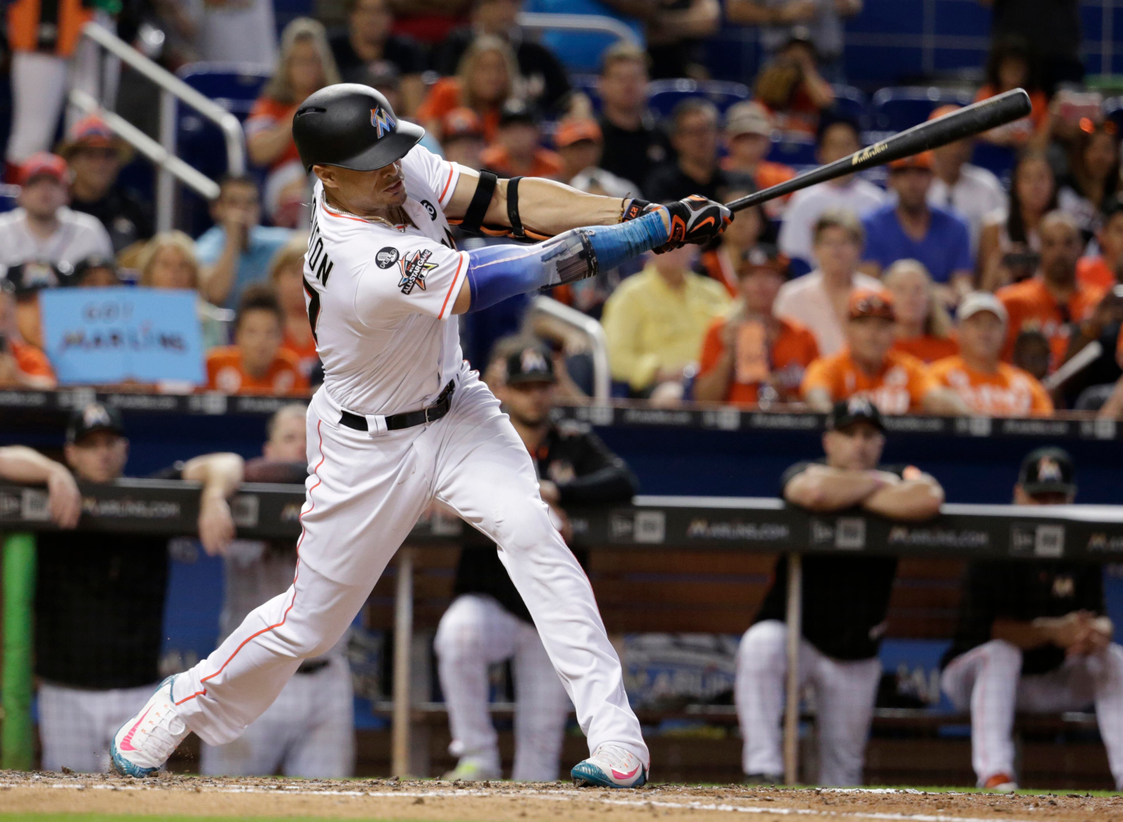 Miami Marlins' Giancarlo Stanton hits a RBI single to score Tyler Moore during the fifth inning of a baseball game against the Atlanta Braves, Sunday, Oct. 1, 2017, in Miami. (AP Photo/Lynne Sladky)