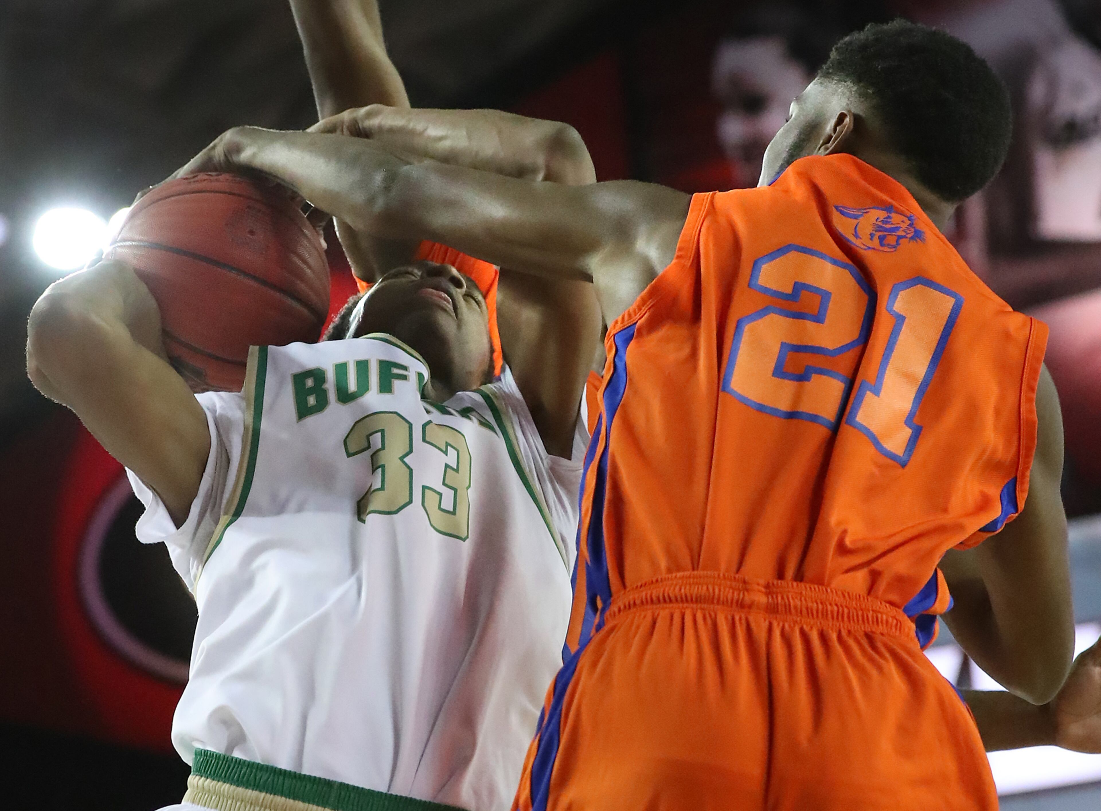 Buford's Jonathan Miles is fouled by Cedar Shoals Tyâqon Mitchell on his way to the basket.