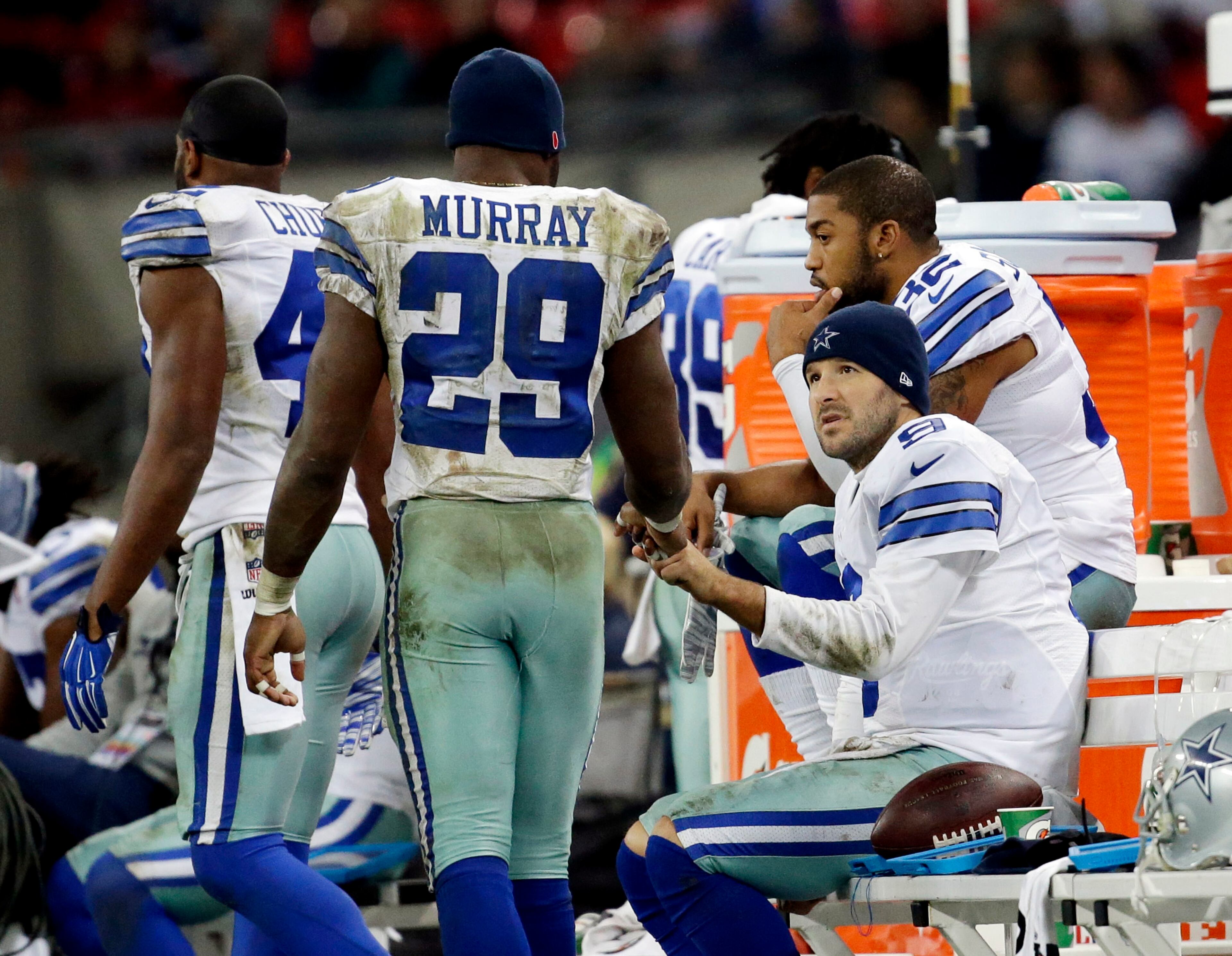 Dallas Cowboys quarterback Tony Romo talks to Dallas Cowboys running back DeMarco Murray during the second half of an NFL football game against the Jacksonville Jaguars at Wembley Stadium, London, Sunday, Nov. 9, 2014. The Cowboys defeated the Jaguars 31-17. (AP Photo/Matt Dunham)