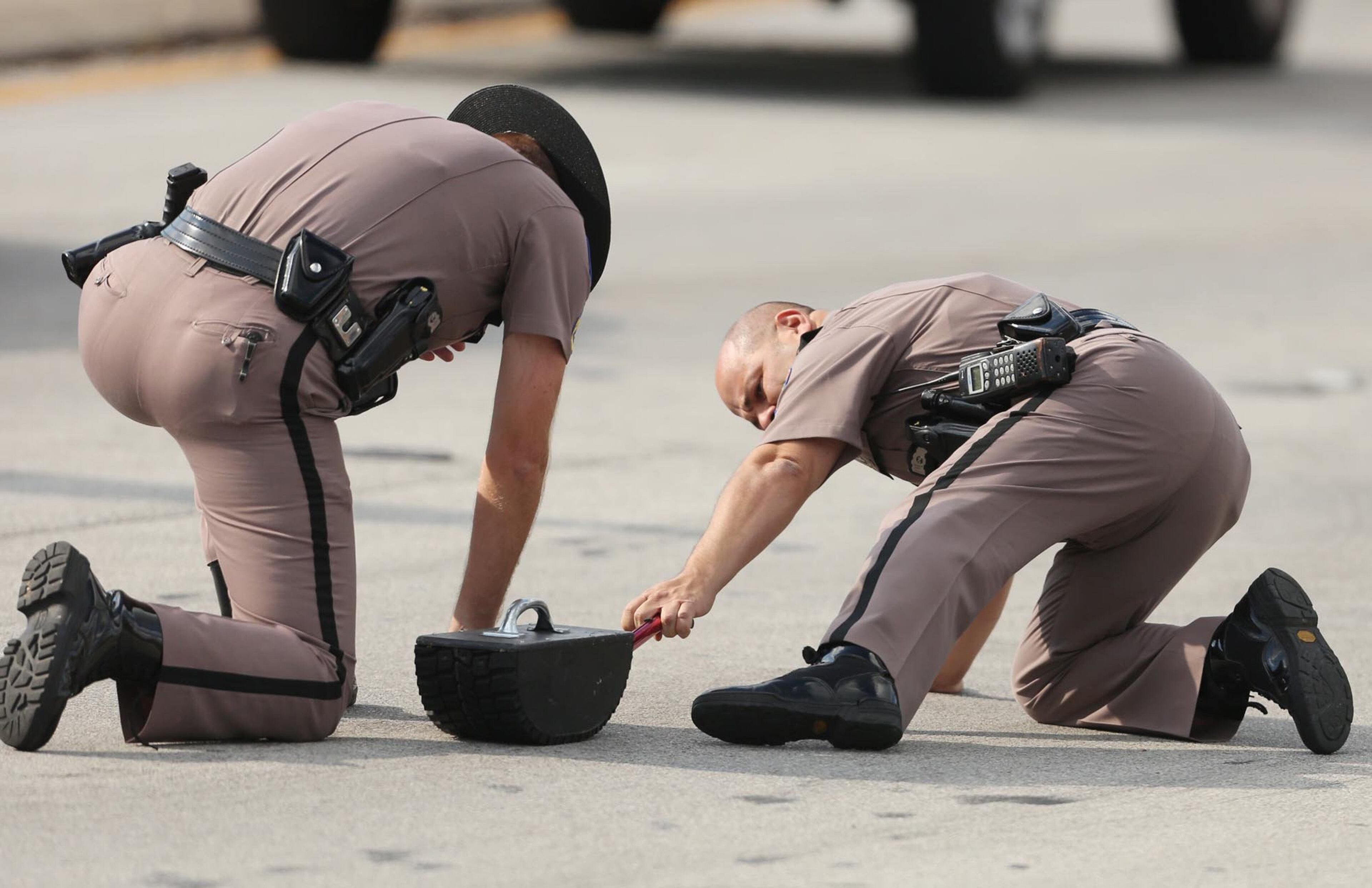 Highway Patrol officers investigate tire skid marks after a car crashed into the KinderCare Learning Center in Winter Park, Fla., Wednesday, April 9, 2014. (Stephen M. Dowell, Orlando Sentinel/MCT)