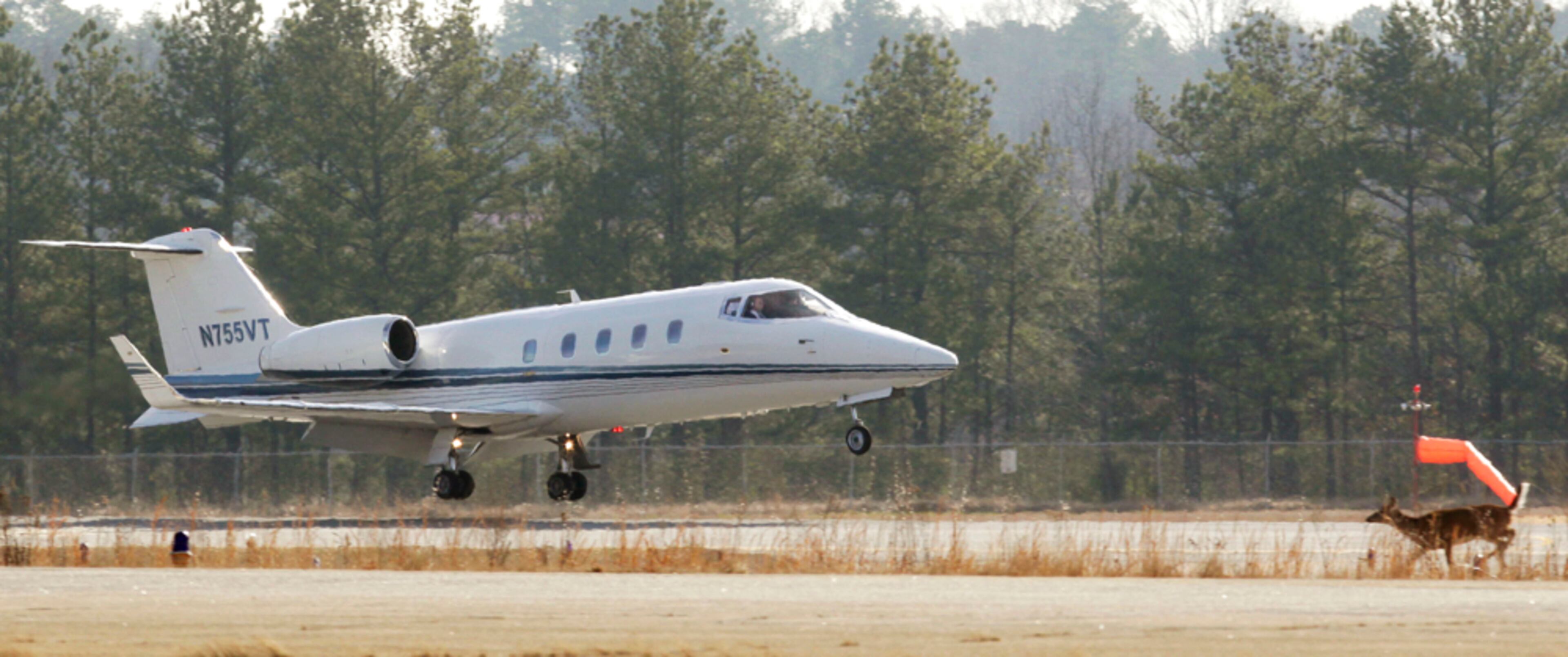 Feb. 7, 2012 - Gwinnett County - A wayward deer scampers across the infield while a small jet aircraft lands at Gwinnett County Airport at Briscoe Field. This is one of my favorite photos of the year. I didn't see the deer until I edited the photos later that afternoon. Bob Andres bandres@ajc.com