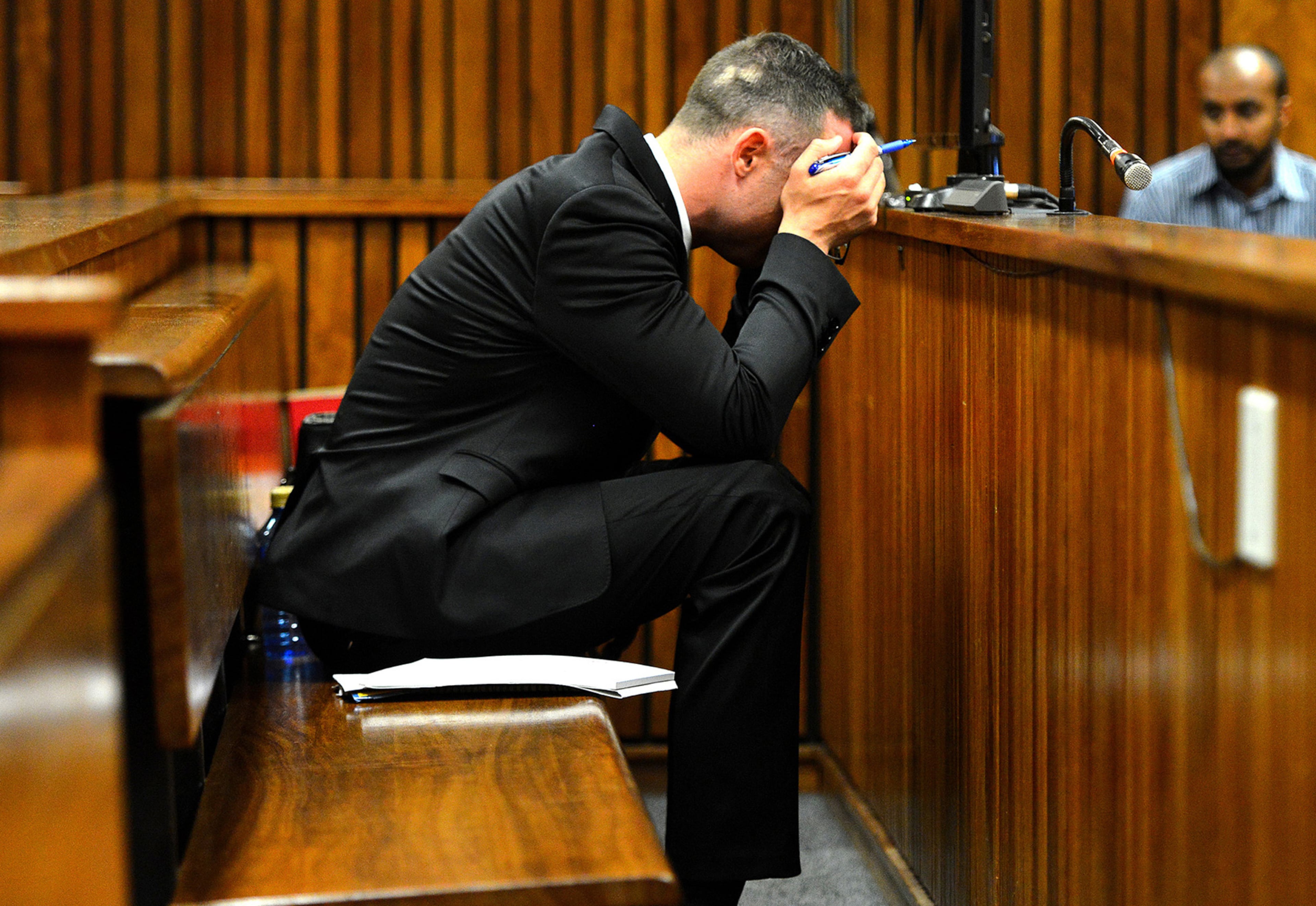 Oscar Pistorius, cradles his head in his hands during court proceedings in Pretoria, South Africa, Monday May 5, 2014 at the resumption of his murder trial, following a two week break. Pistorius is charged with the shooting death of his girlfriend Reeva Steenkamp on Valentine's Day in 2013. (AP Photo/Thobile Mathonsi, Pool)