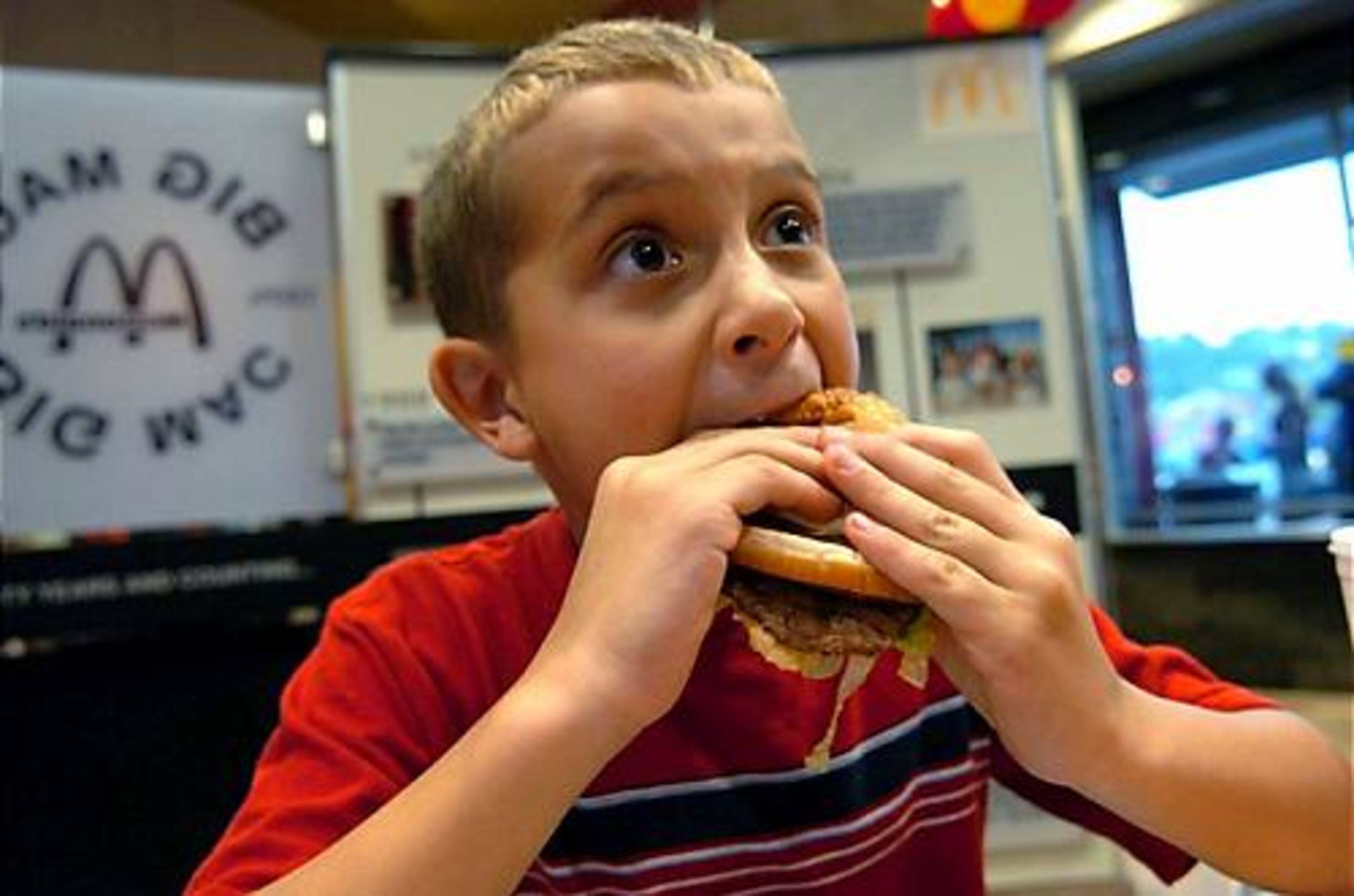 Jason Senica, 8, of Adamsburg, Pa., enjoys his Big Mac during the opening of the Big Mac Museum Restaurant in North Huntingdon, Pa.