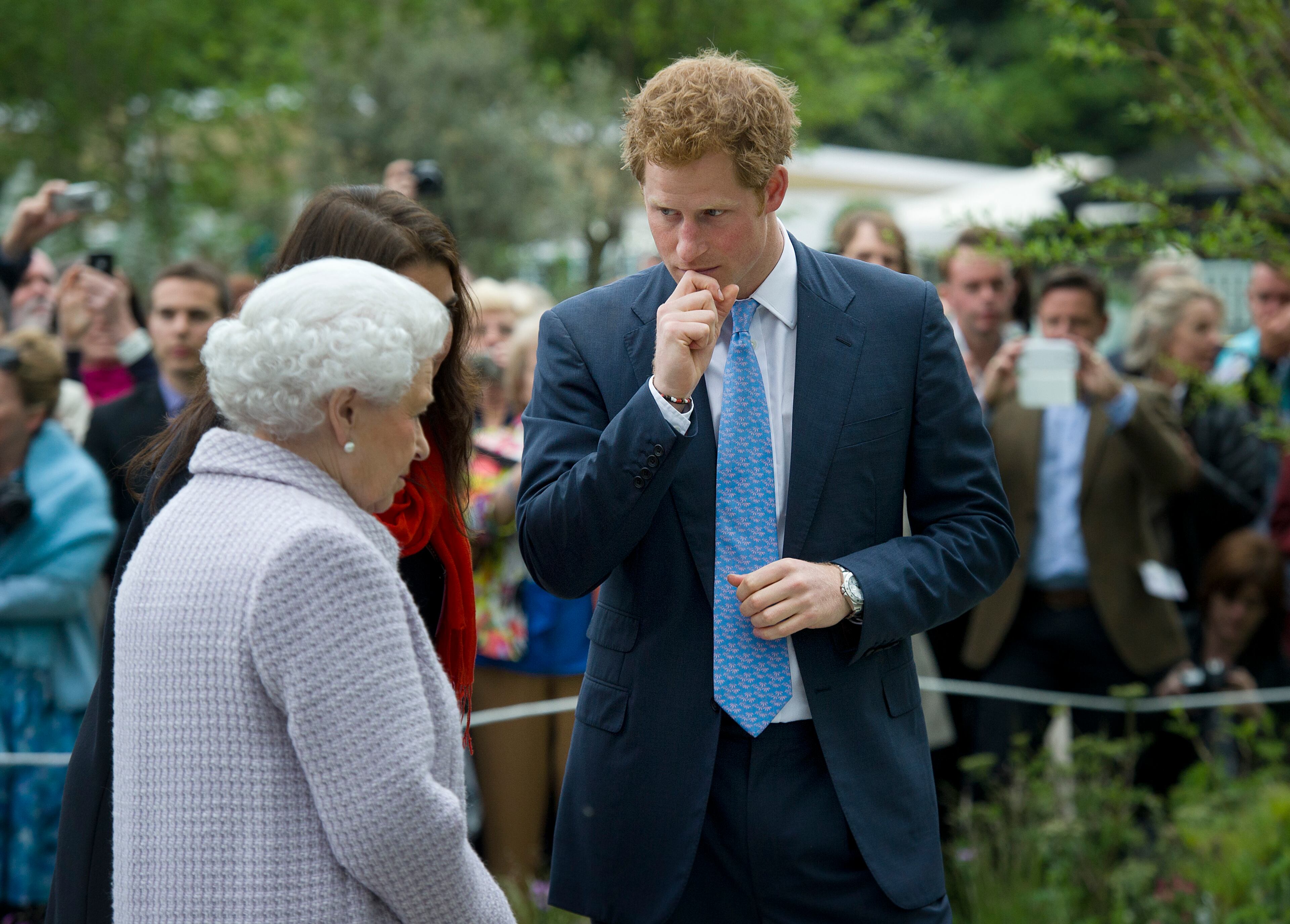 Queen Elizabeth II and Prince Harry visit the Sentebale Forget-me-not garden the Chelsea Flower Show press and VIP preview day at Royal Hospital Chelsea on May 20, 2013 in London, England. (Photo by Geoff Pugh - WPA Pool/Getty Images)