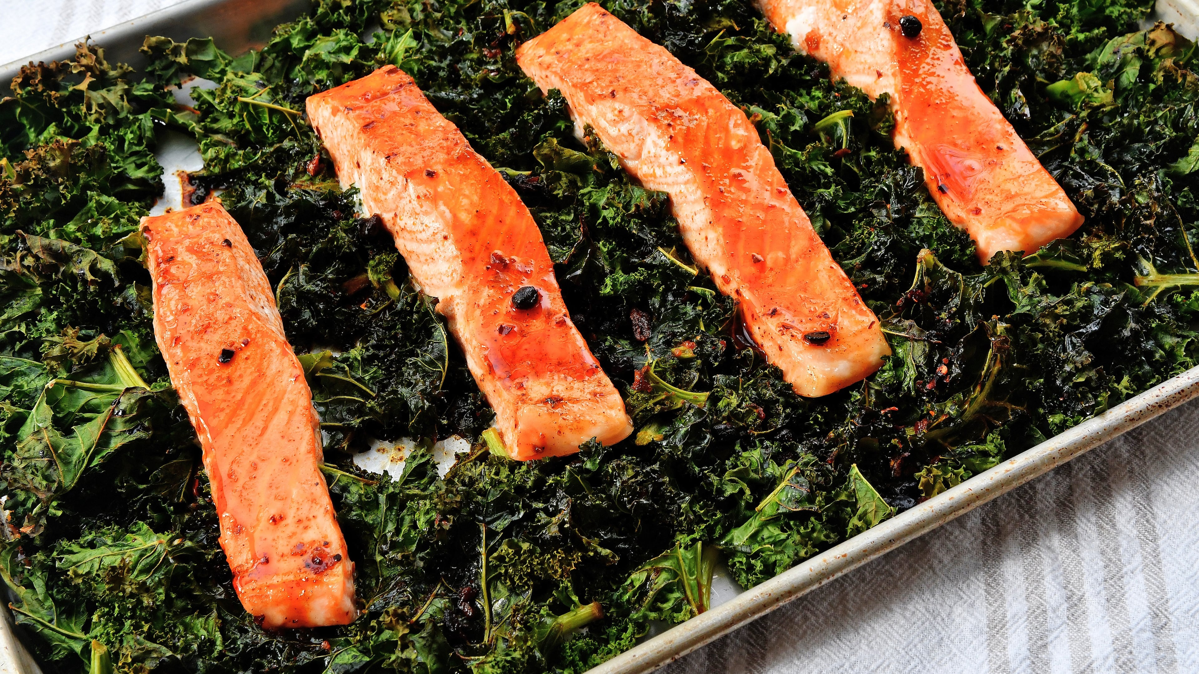 Roasted Salmon and Kale with Chili Crisp. (Chris Hunt for The Atlanta Journal-Constitution)