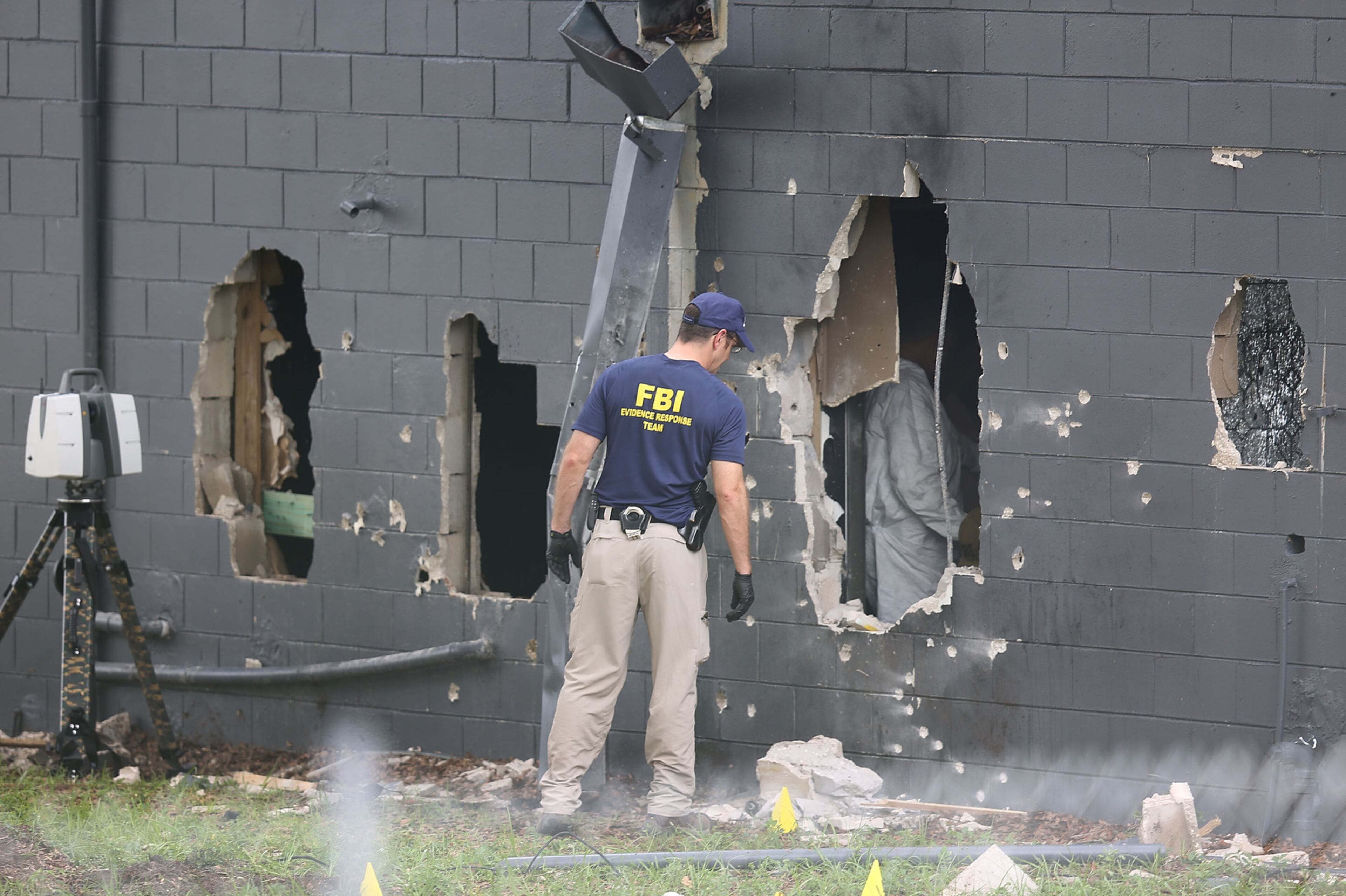 INVESTIGATION SCENE--ORLANDO, FL - JUNE 12: FBI agents investigate the damaged rear wall of the Pulse Nightclub where Omar Mateen allegedly killed at least 50 people on June 12, 2016 in Orlando, Florida. The mass shooting killed at least 50 people and injured 53 others in what is the deadliest mass shooting in the country's history. (Photo by Joe Raedle/Getty Images)