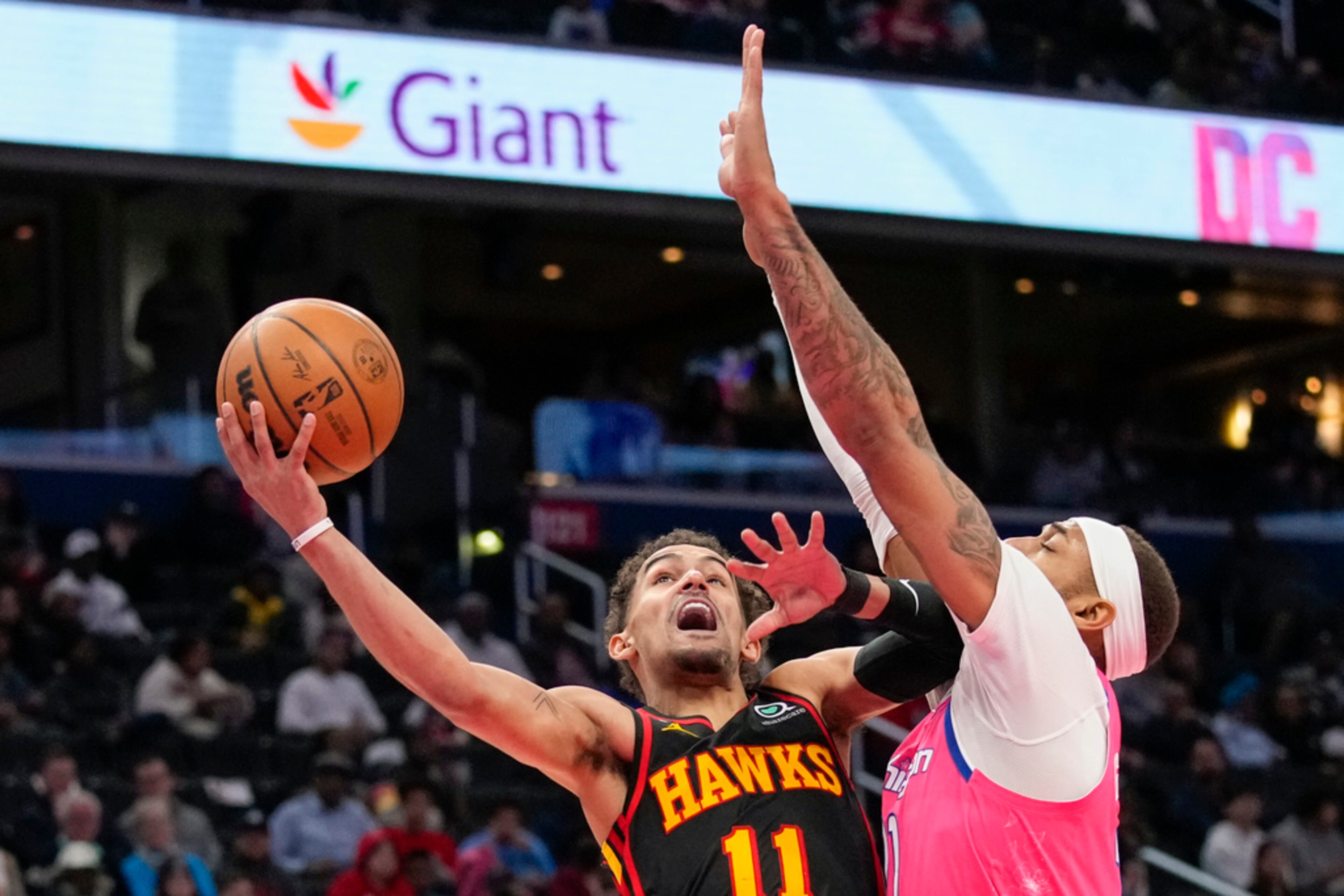 Atlanta Hawks guard Trae Young (11) shoots over Washington Wizards center Daniel Gafford (21) during the second half of an NBA basketball game Wednesday, March 8, 2023, in Washington. The Hawks won 122-120. (AP Photo/Alex Brandon)