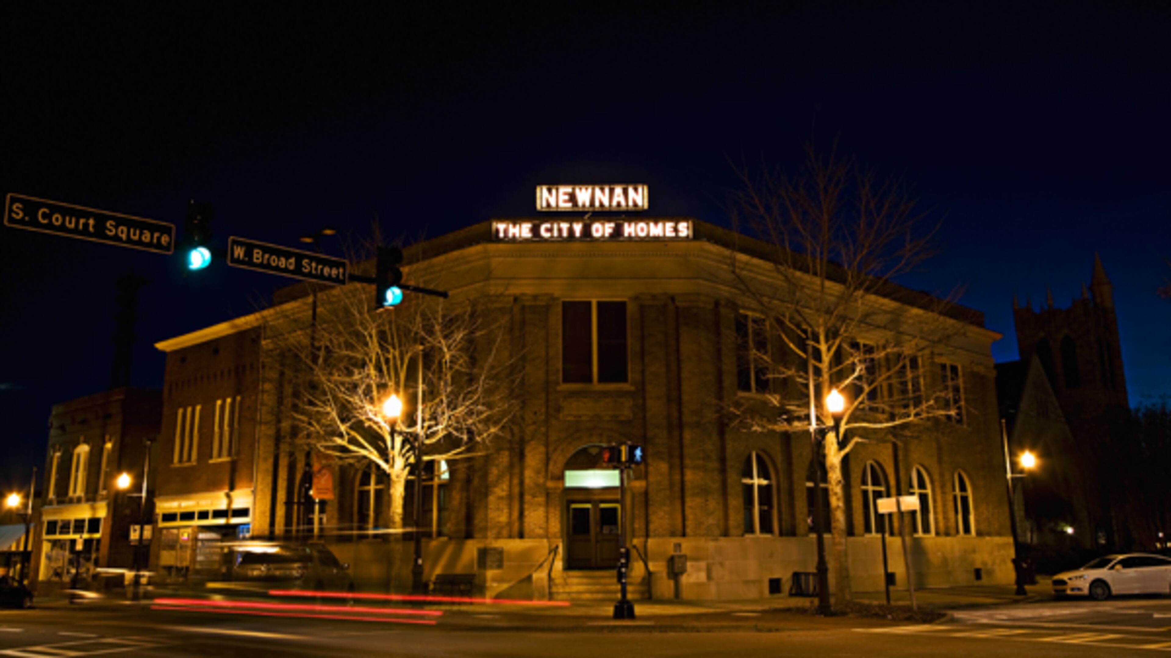 Caption: The City of Homes sign hangs from the top of the Newnan Carnegie Library building in downtown Newnan. Credit: City of Newnan