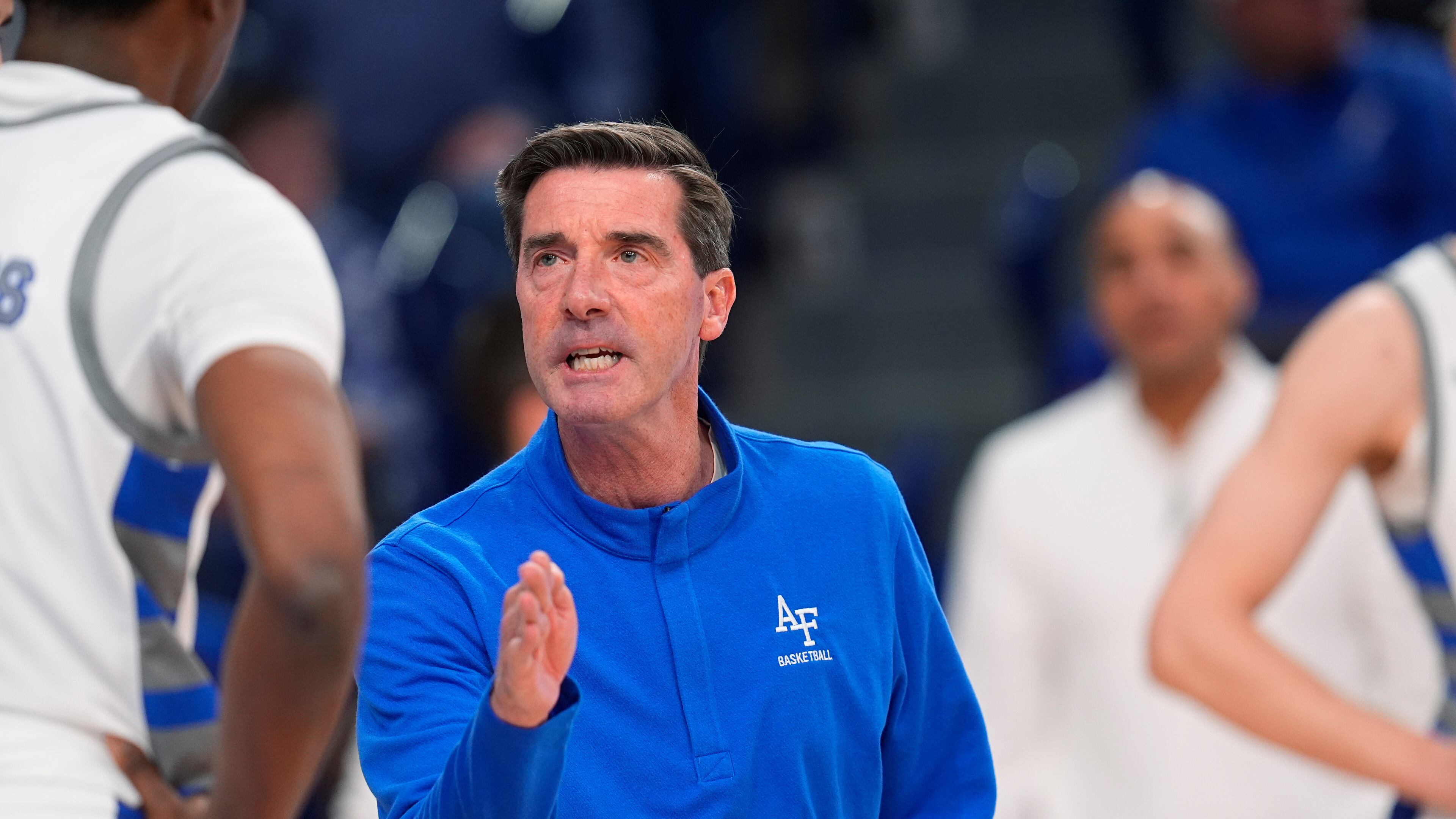 FILE - Air Force head coach Joe Scott confers with Air Force guard Byron Brown (11) in the first half of an NCAA college basketball game, on Feb. 6, 2024, at Air Force Academy, Colo. (AP Photo/David Zalubowski, File)