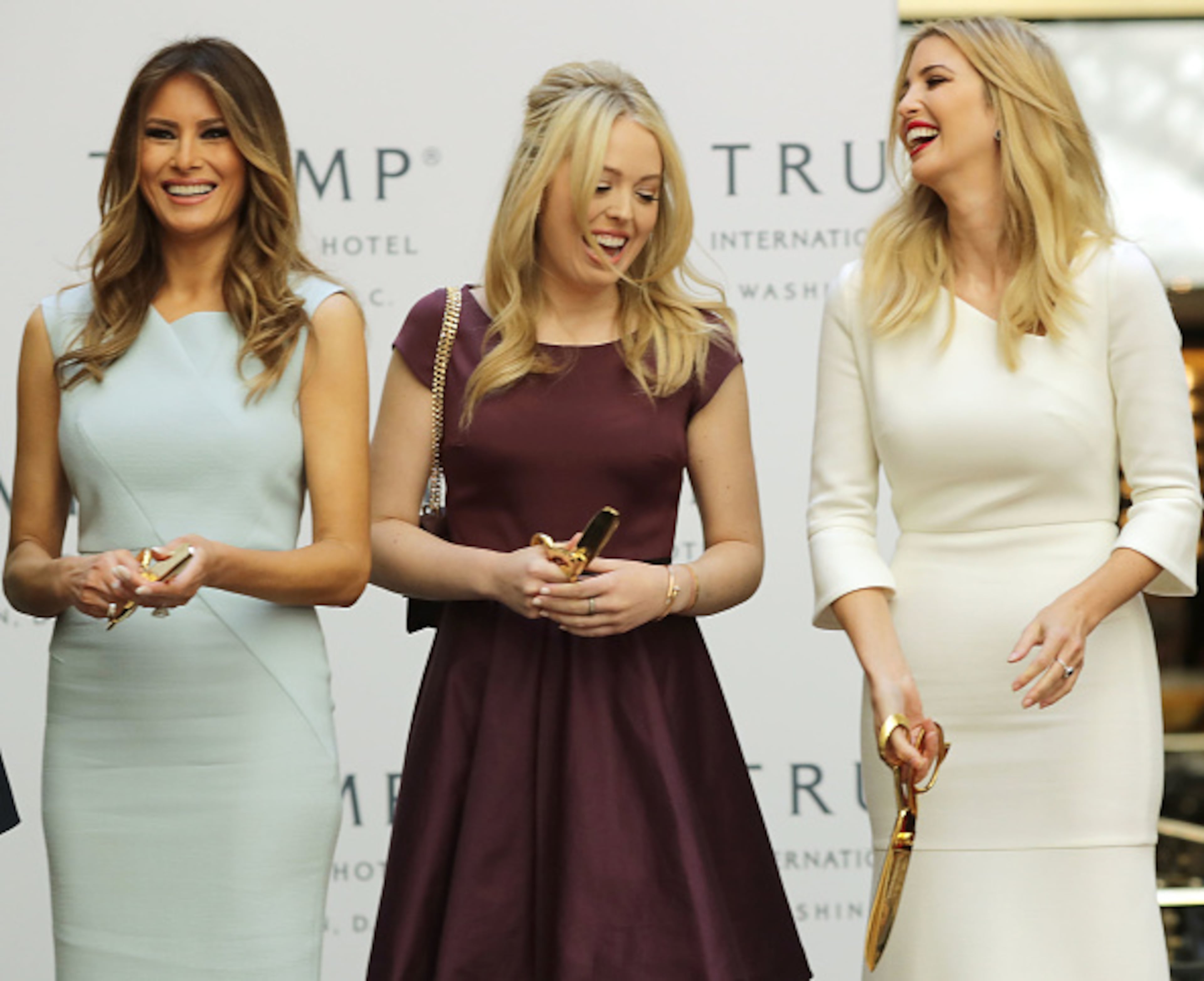 WASHINGTON, DC - OCTOBER 26: (L-R) Melania Trump, wife of Republican presidential nominee Donald Trump, and his daughters Tiffany Trump and Ivanka Trump laugh after cutting the ribbon at the new Trump International Hotel October 26, 2016 in Washington, DC. The hotel, built inside the historic Old Post Office, has 263 luxry rooms, including the 6,300-square-foot 'Trump Townhouse' at $100,000 a night, with a five-night minimum. The Trump Organization was granted a 60-year lease to the historic building by the federal government before the billionaire New York real estate mogul announced his intent to run for president. (Photo by Chip Somodevilla/Getty Images)