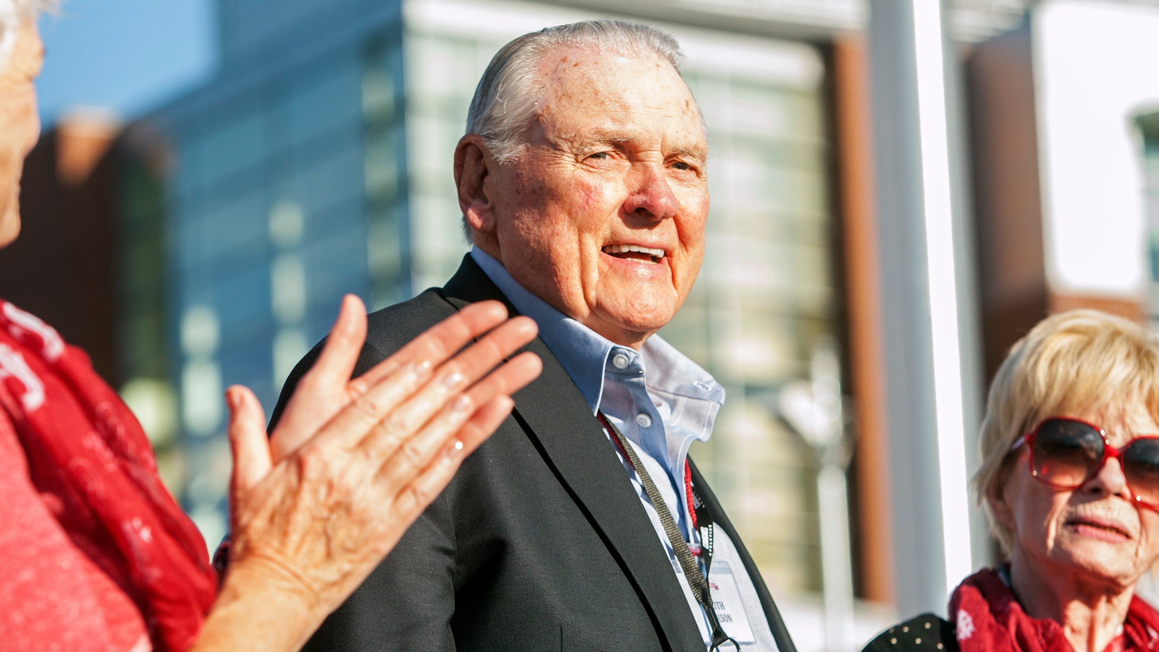 Keith Jackson smiles after raising the Cougar flag before the start of an NCAA college football game against Portland State at Martin Stadium in Pullman, Wash. Jackson, the down-home voice of college football during more than five decades as a broadcaster, died Friday, Jan. 12, 2018. He was 89.