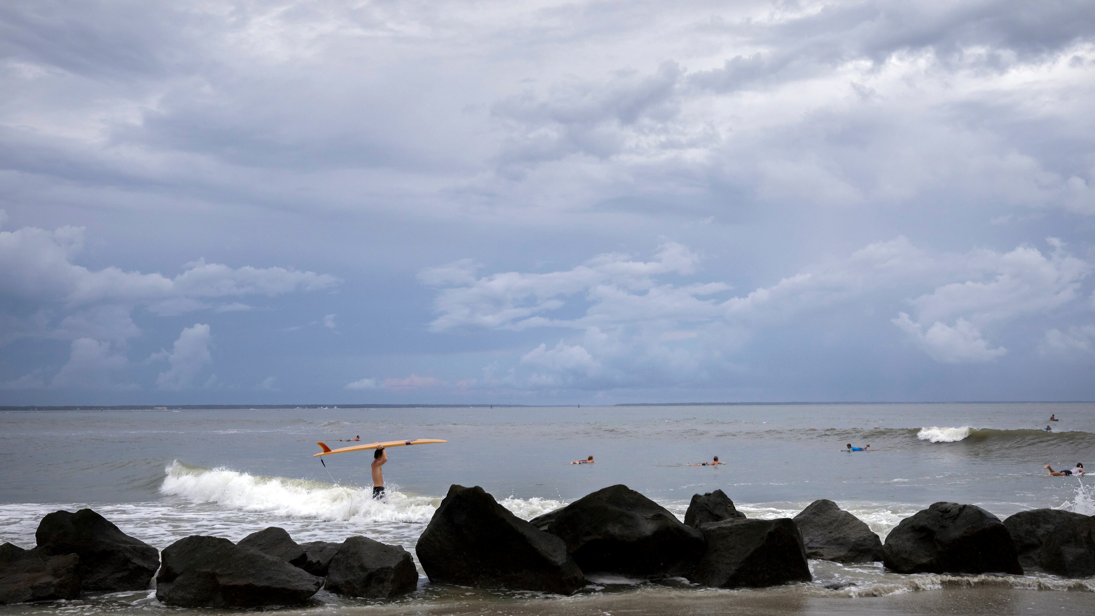 TYBEE ISLAND, GA - AUGUST 29, 2023: Surfers along Tybee IslandÕs north beach paddle out to some rare swells, Tuesday, Aug., 29, 2023 ahead of Hurricane Idalia. The storm strengthened into a hurricane Tuesday and is barreling toward FloridaÕs Gulf Coast and will likely come ashore early Wednesday as a Category 3 system with sustained winds of up to 120 mph. (AJC Photo/Stephen B. Morton)(AJC Photo/Stephen B. Morton)