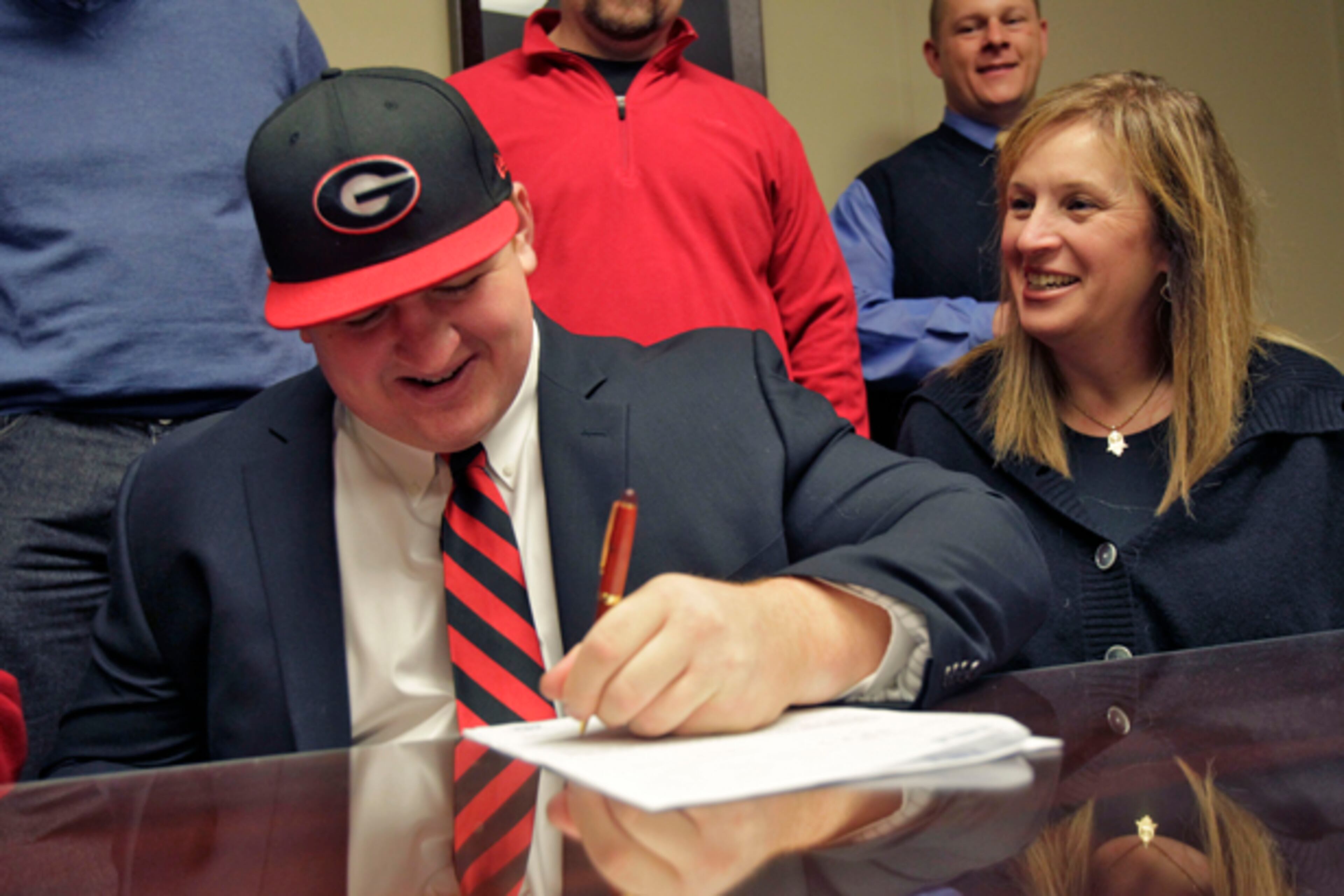Walton's Brandon Kublanow, an AJC Super 11 athlete, signs with Georgia on National Signing Day, with his mother, Shelly Rosenblatt, at his side.
