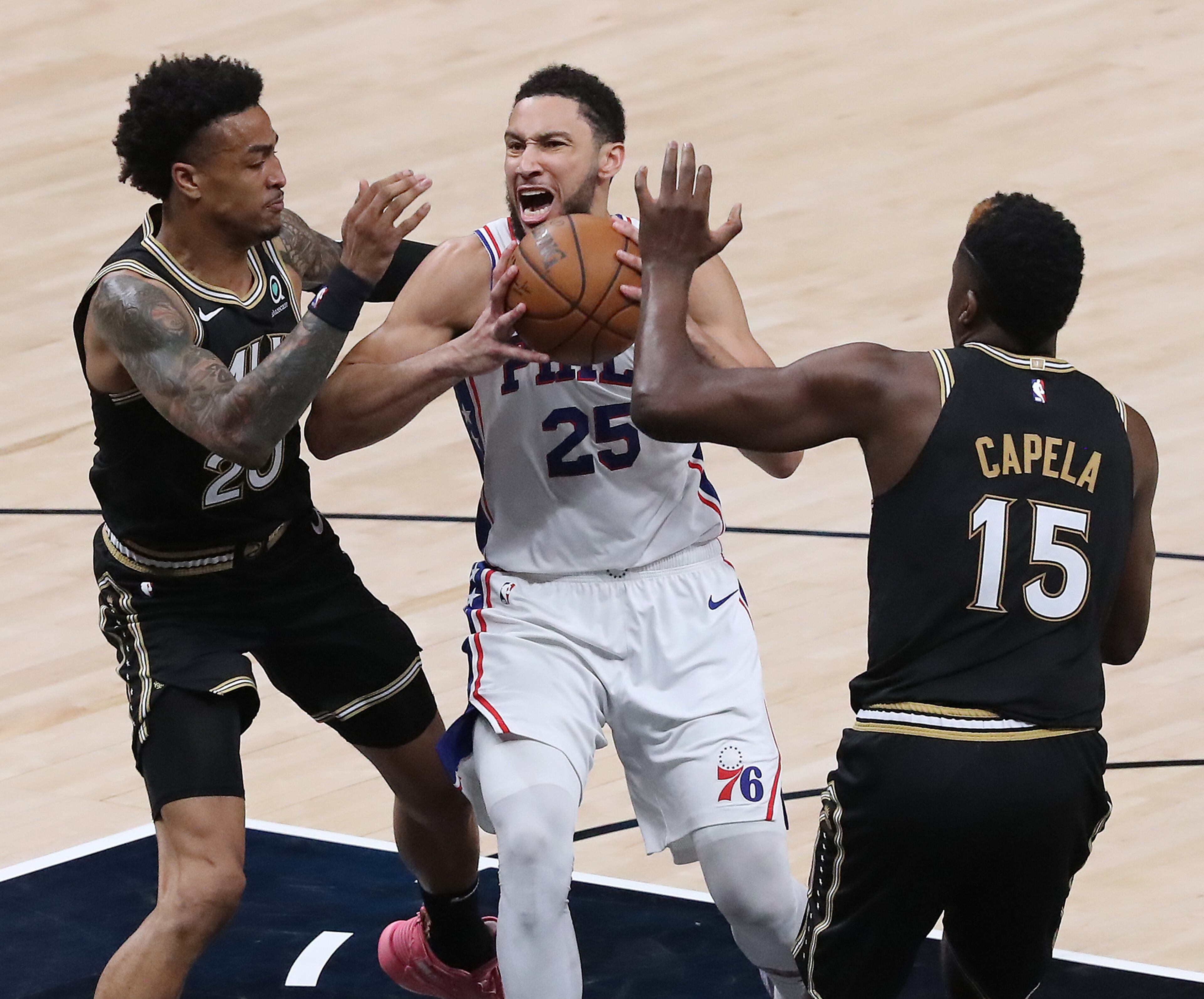 Atlanta Hawks forward John Collins and center Clint Capela defend against Philadelphia 76ers guard Ben Simmons. “Curtis Compton / Curtis.Compton@ajc.com”