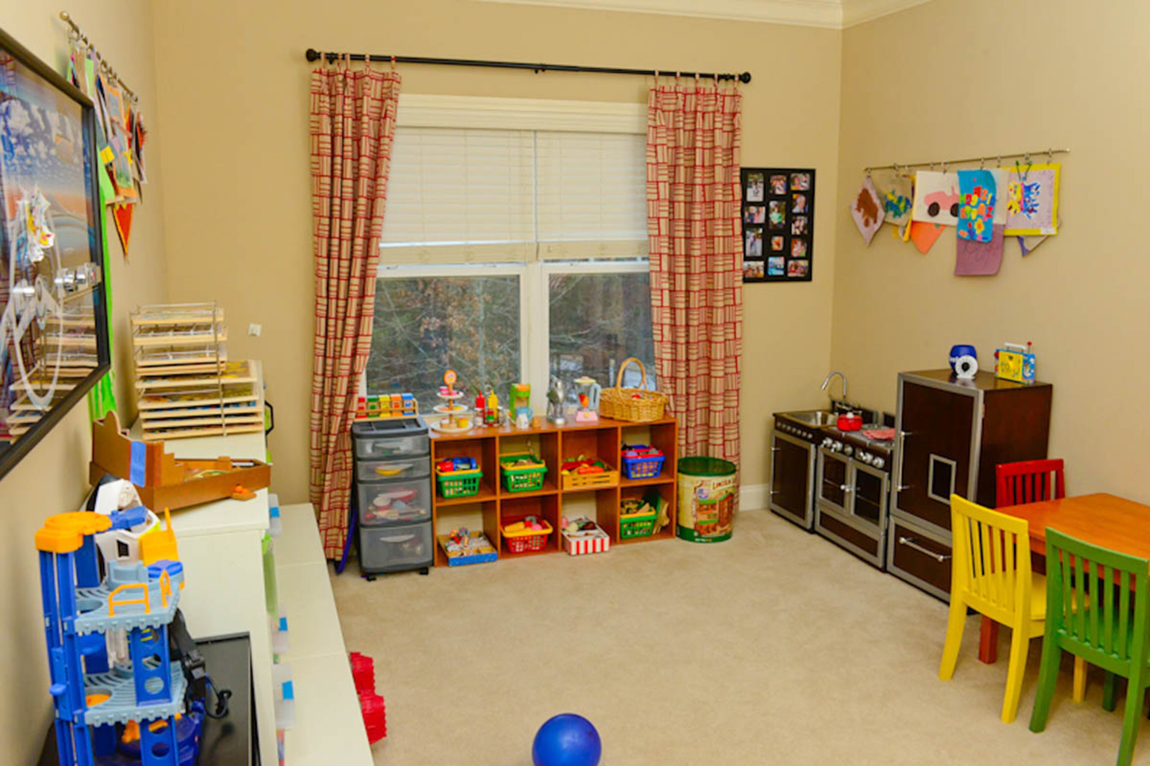 The boys' playroom is a colorful and creative space, with plenty of bins and containers to keep items organized.