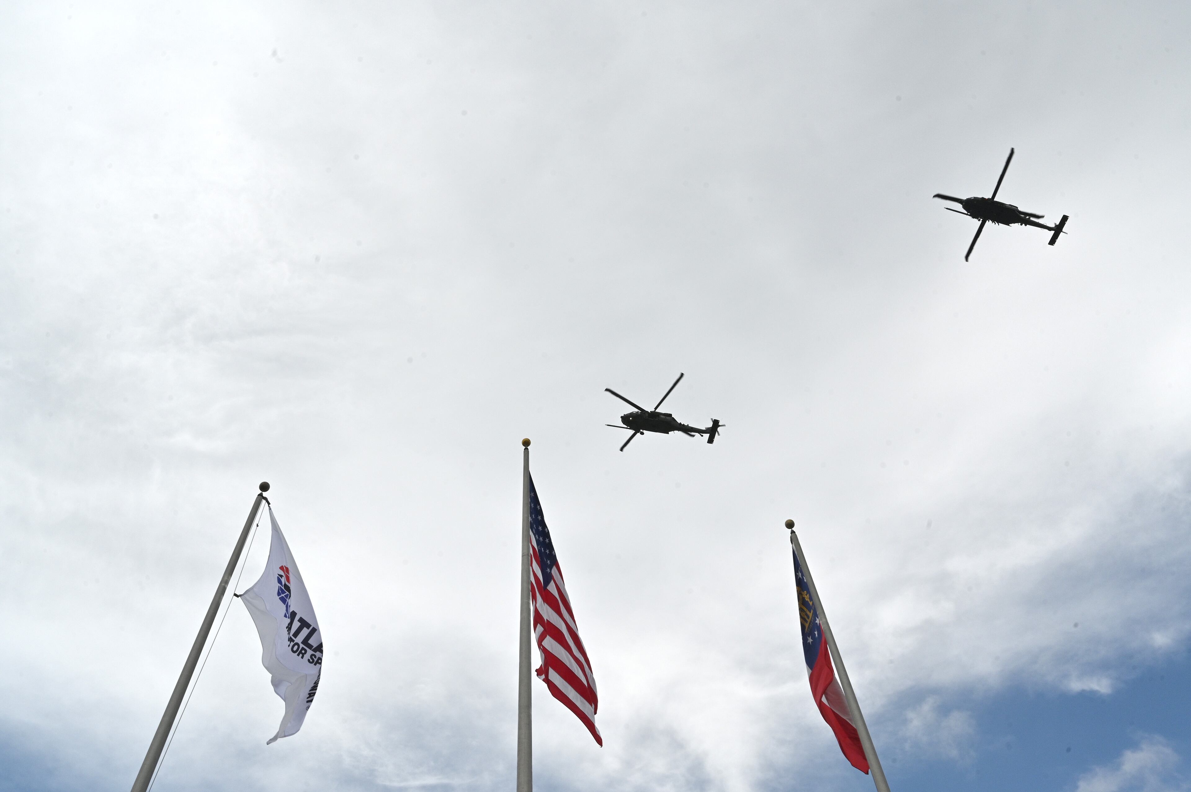 Two helicopters from Moody Air Force Base in Valdosta perform a fly-over before the start of the Quaker State 400 presented by Walmart Sunday, July 11, 2021, at Atlanta Motor Speedway in Hampton. (Hyosub Shin / Hyosub.Shin@ajc.com)