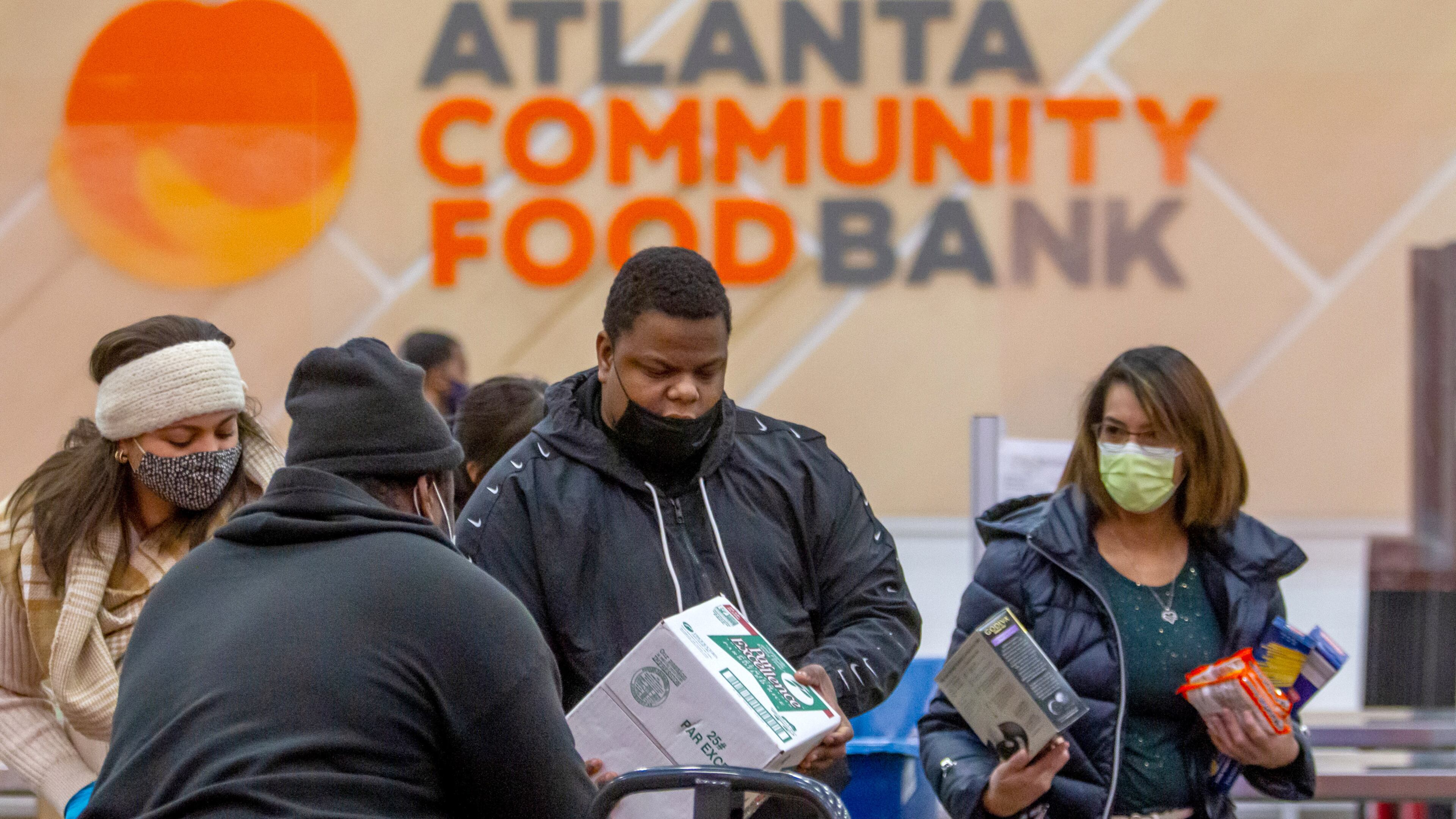 Hunger Action volunteers sort food into their appropriate boxes at the Atlanta Community Food Bank Thursday, 23, 2021. STEVE SCHAEFER FOR THE ATLANTA JOURNAL-CONSTITUTION
