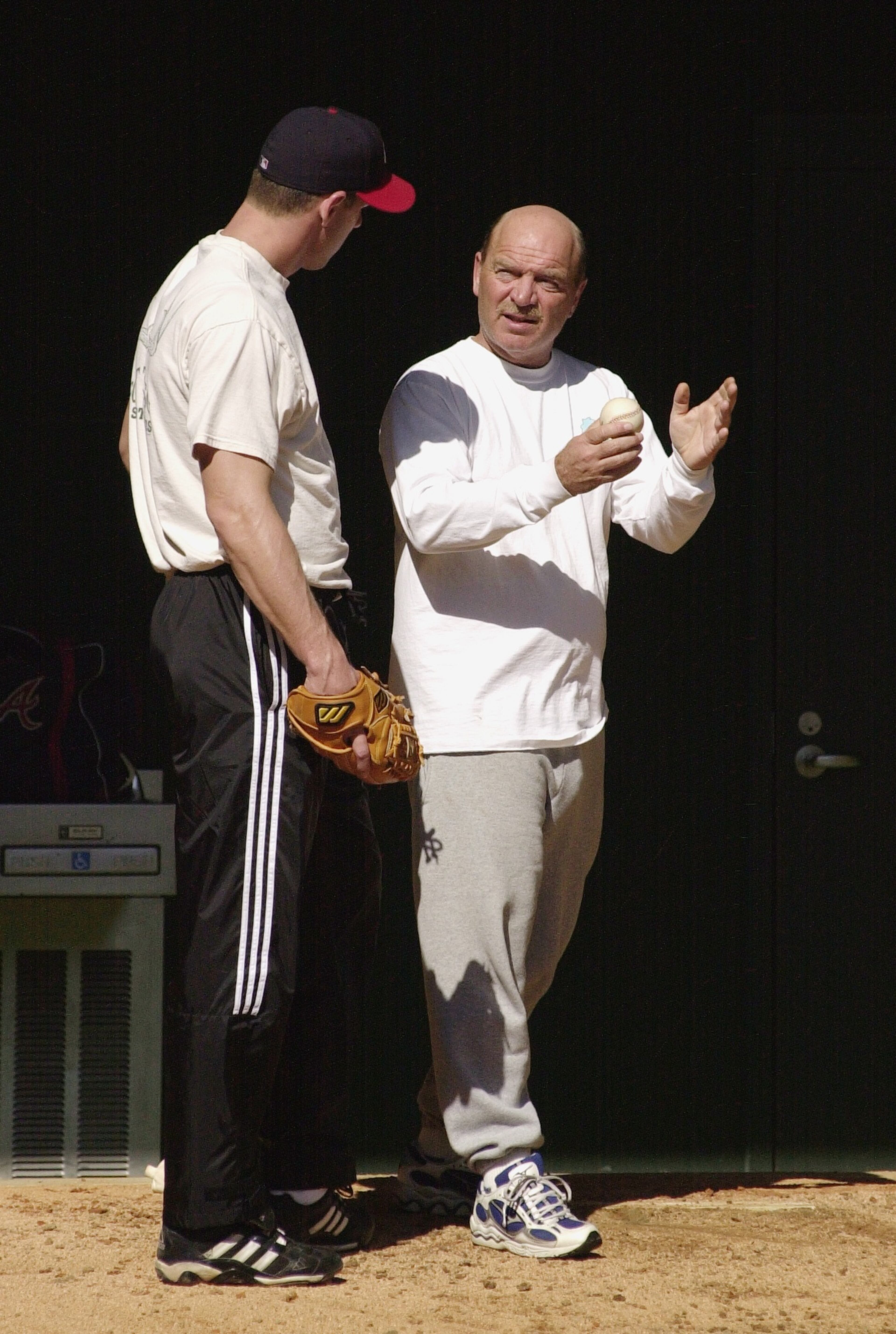 John Rocker (left) gets some tips from Mazzone in 2001.