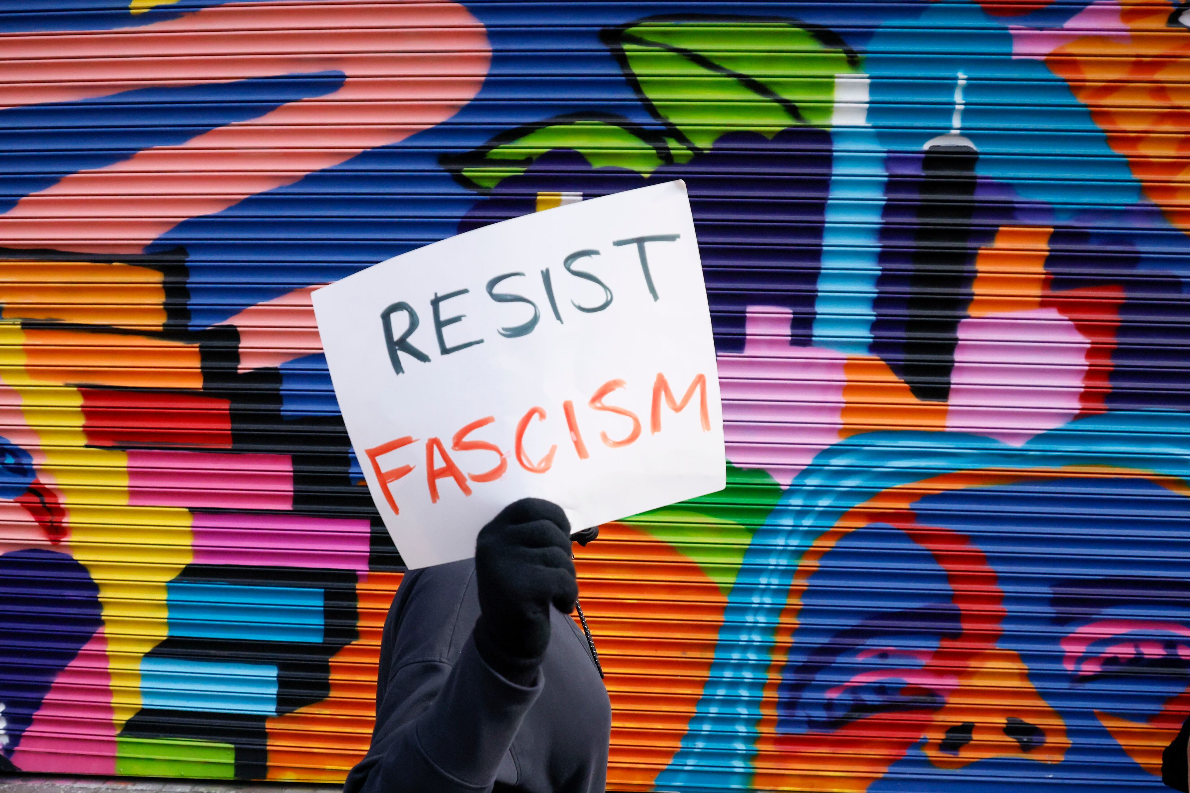 A person holds a sign as he marches alongside activists during a rally against Trump’s executive actions on Wednesday, Feb. 5, 2025.
(Miguel Martinez/ AJC)