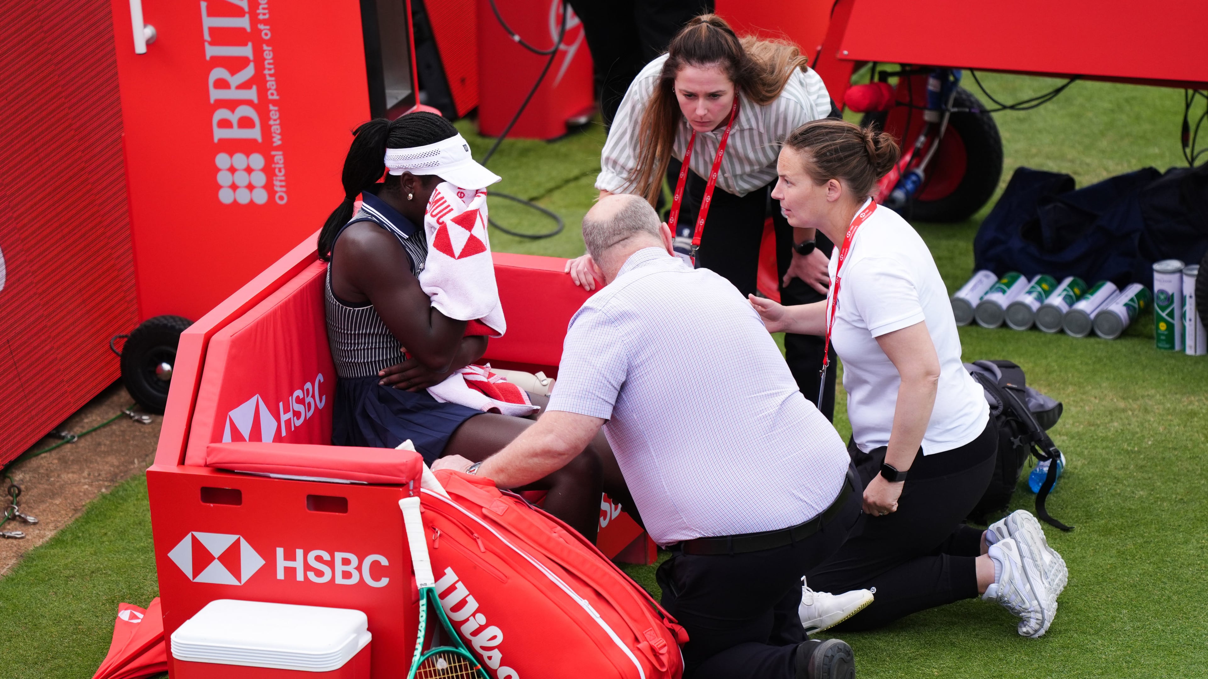 Victoria Mboko, left, of Canada retires injured during her match against Karolina Pliskova of Czech Republic on day three of the Queen's Club tennis championships in London, Wednesday, June 10, 2026. (Ben Whitley/PA via AP)