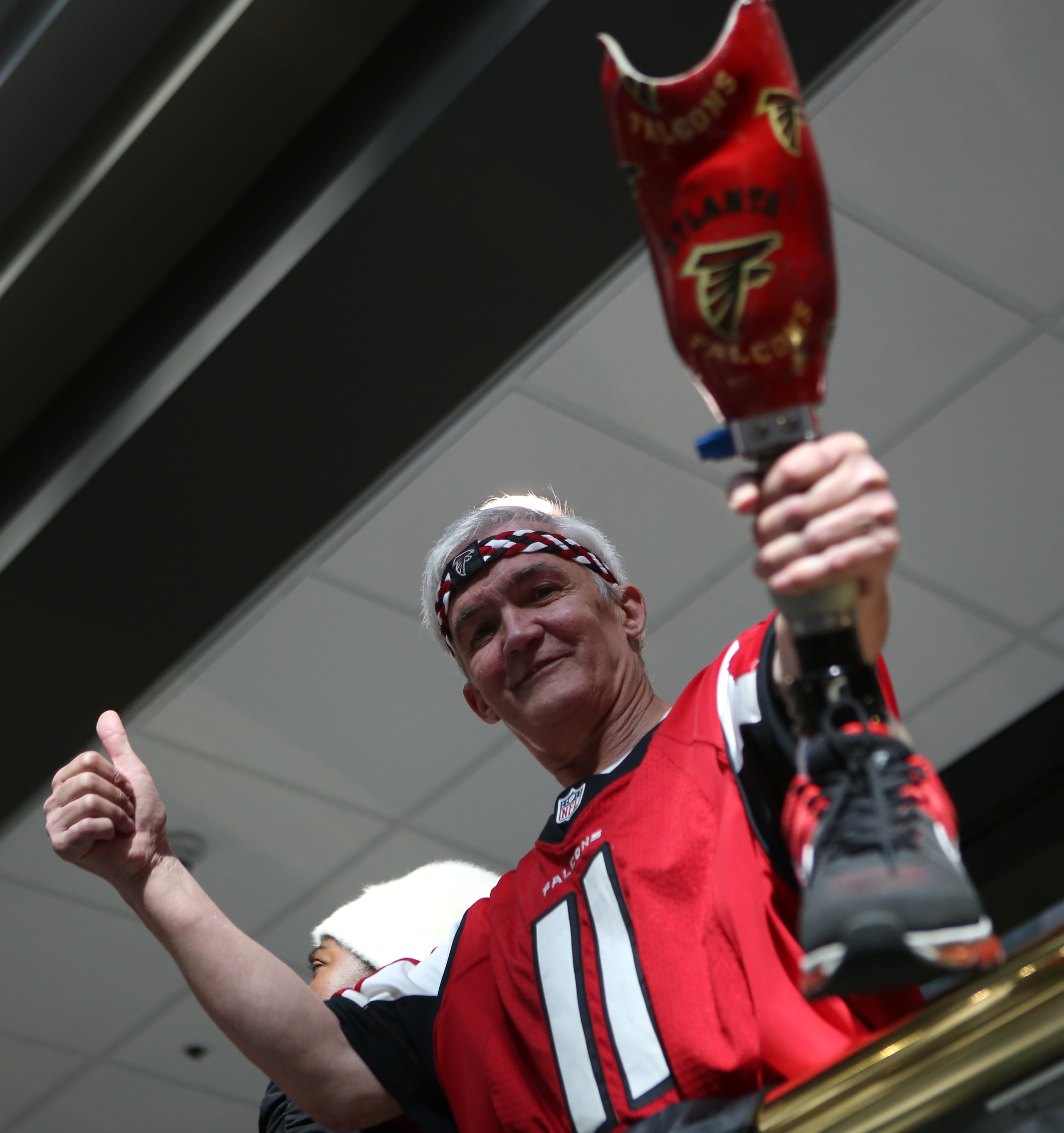 January 27, 2017, Atlanta, Georgia - A fan shows off his Falcons prosthetic leg at the Atlanta Falcons pep rally held by Mayor Kasim Reed at City hall in Atlanta, Georgia, on Friday, January 27, 2017. (HENRY TAYLOR / HENRY.TAYLOR@AJC.COM)