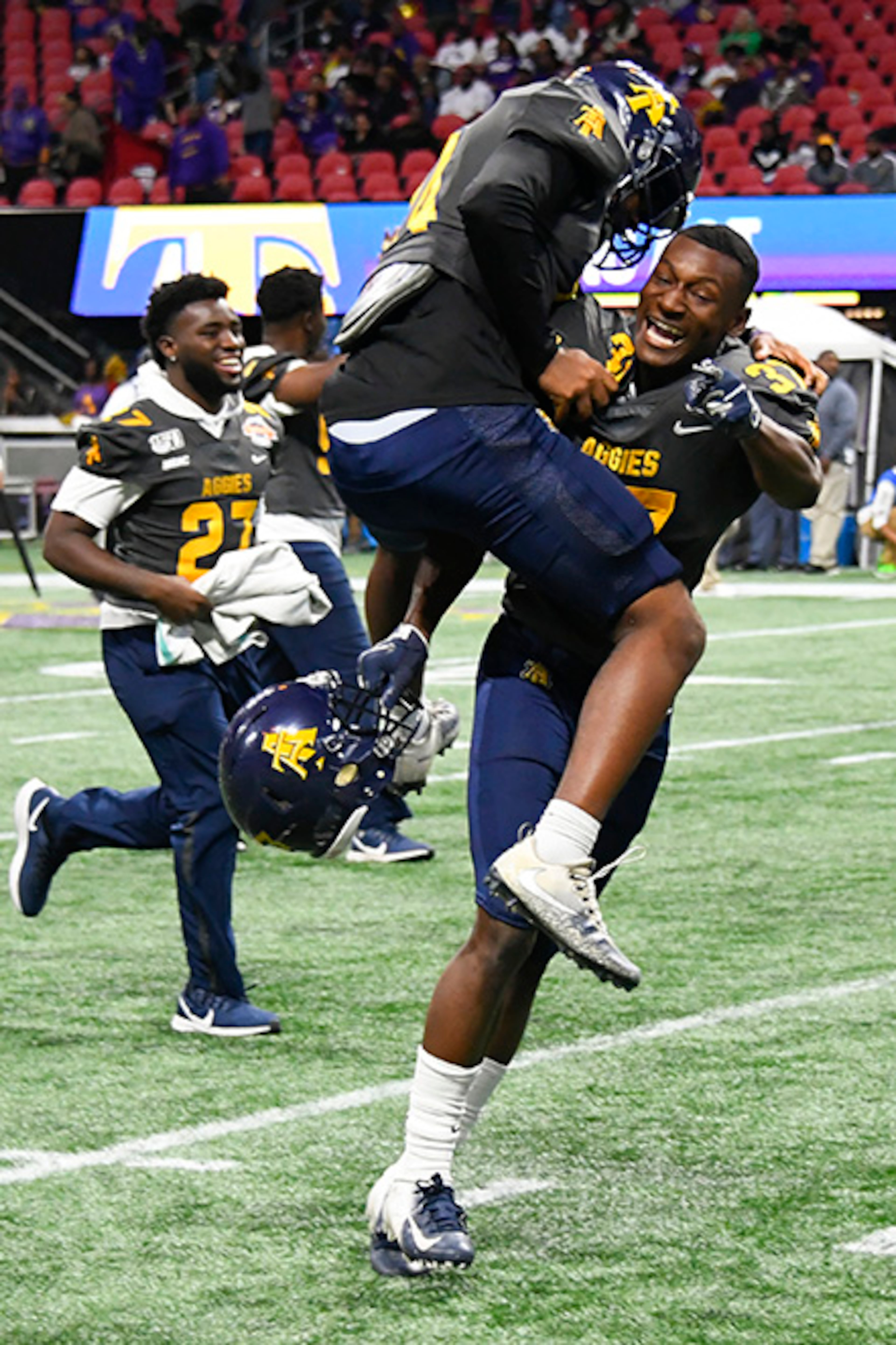 North Carolina A&T defensive back Herbert Booker leaps into the arms of North Carolina A&T defensive back Janaz Sumpter after the Celebration Bowl Saturday, Dec. 21, 2019, at Mercedes-Benz Stadium in Atlanta.