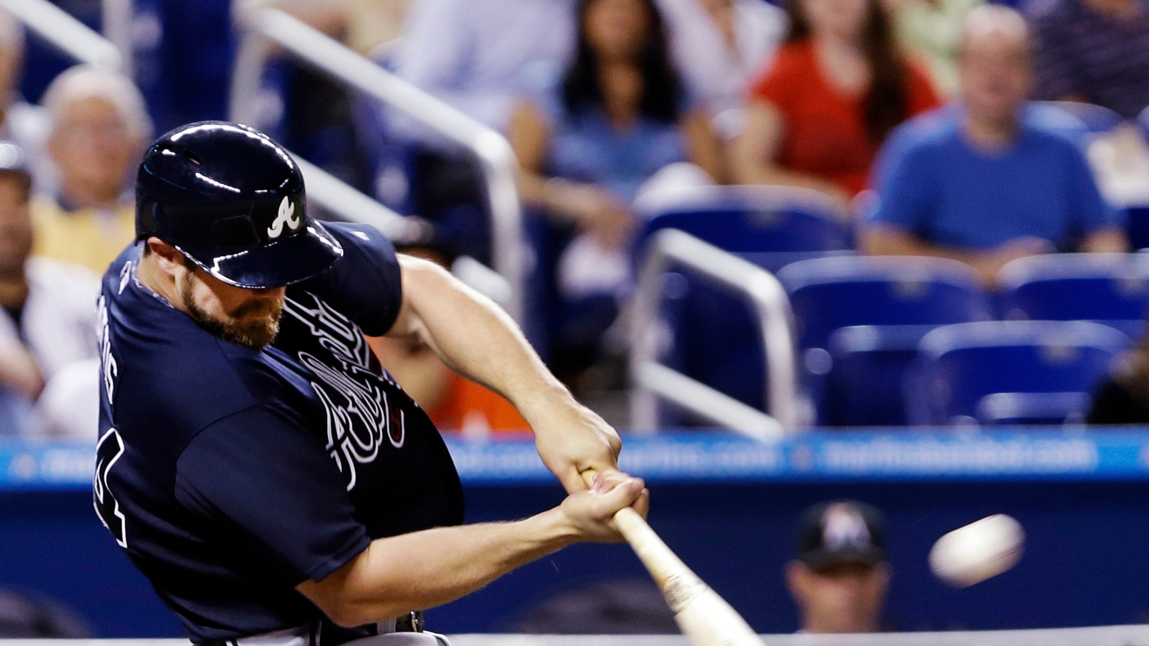 Evan Gattis hits a three-run home run during the fifth inning of a baseball game against the Miami Marlins, Wednesday, April 10, 2013, in Miami. Andrelton Simmons and Jason Heyward scored on the hit.