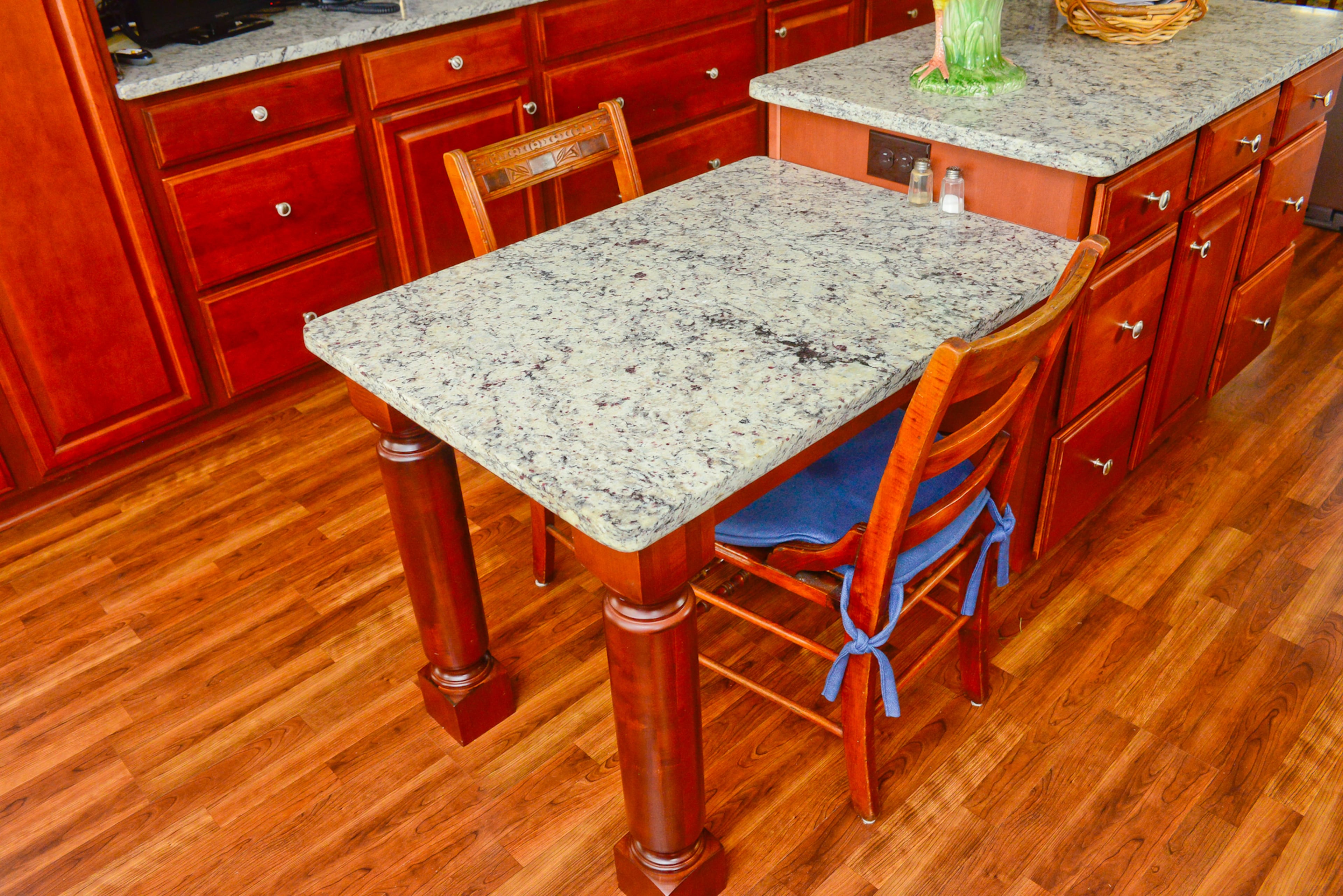 Linda added a drop-down table connected to the kitchen island after seeing something similar in another home. She and Chris sit here for breakfast and snacks, and often use the surface for puzzles, sewing and reading the newspaper.