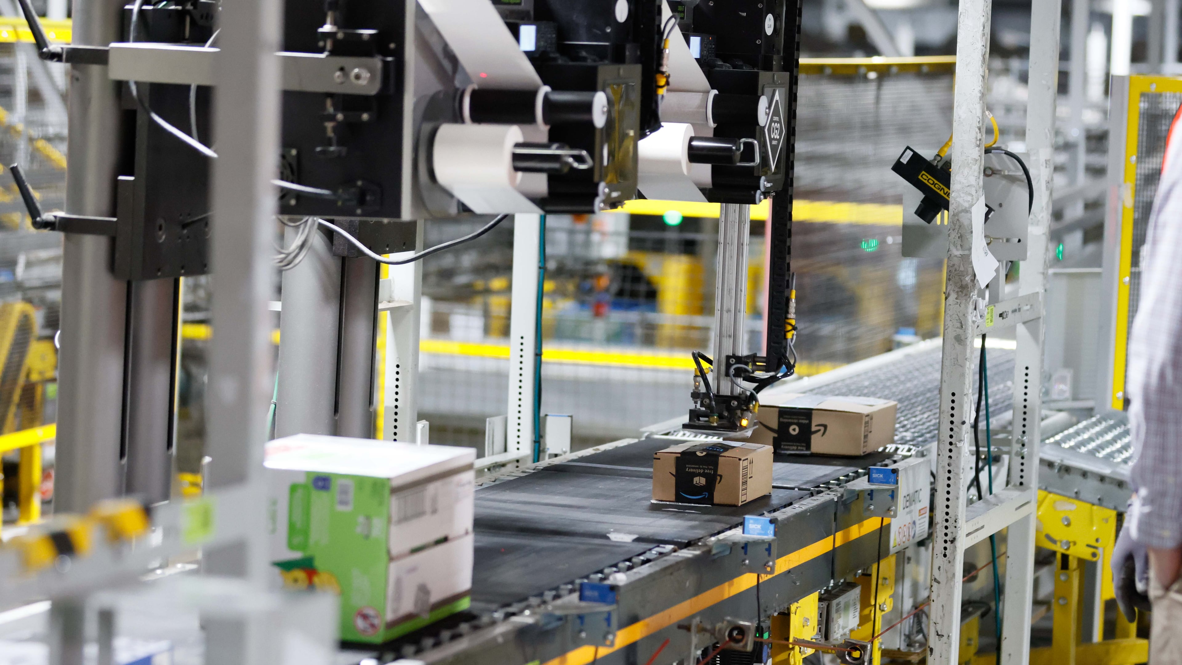 An automated machine is seen placing a sticker on an Amazon package at the Amazon Distribution Center in Stone Mountain. Amazon plans to convert a South Fulton warehouse into a “first mile” fulfillment center to do initial sorting and packaging.
(Miguel Martinez/AJC)